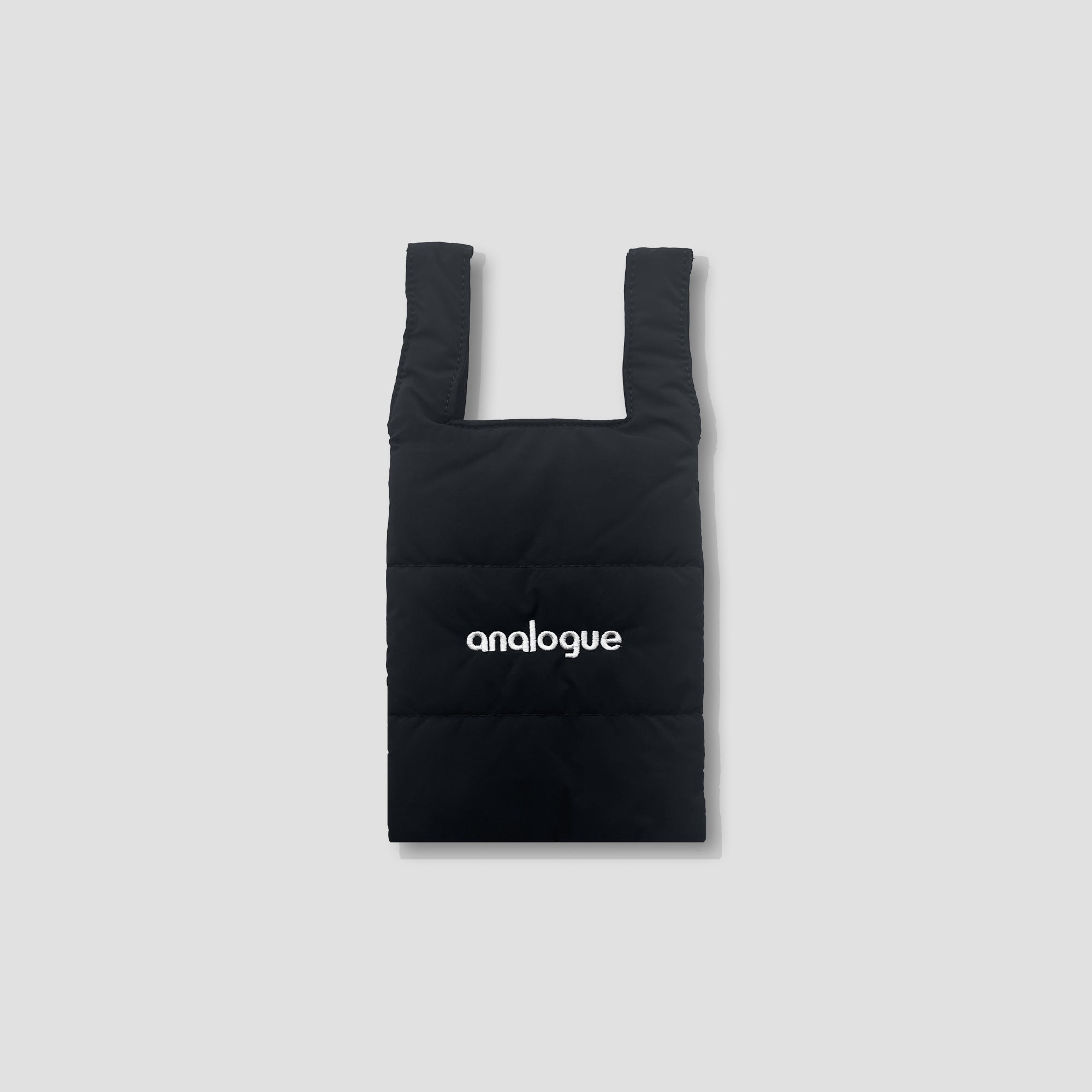 Chic crossbody photography bag showcasing its puffy material and magnetic closure