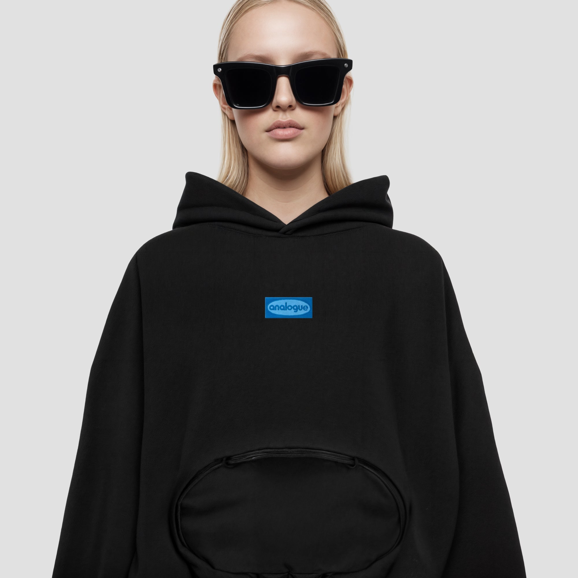 Close-up of blue embroidered patch on womens cropped hoodie