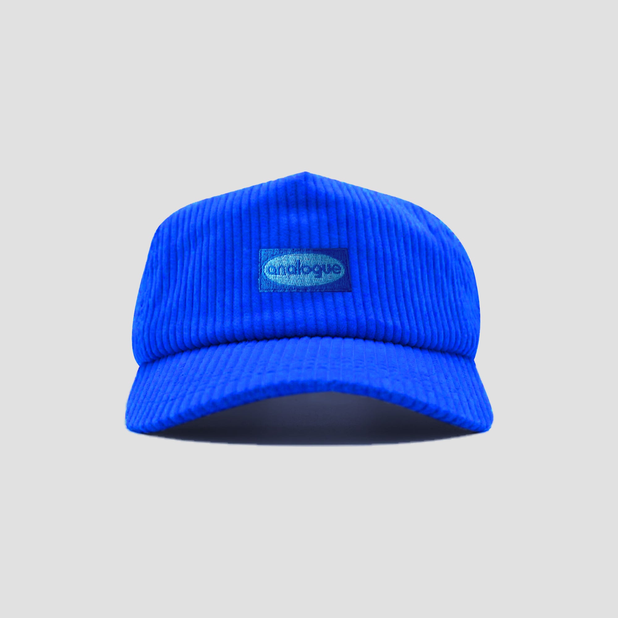 Premium blue corduroy cap with embroidered logo, side view.