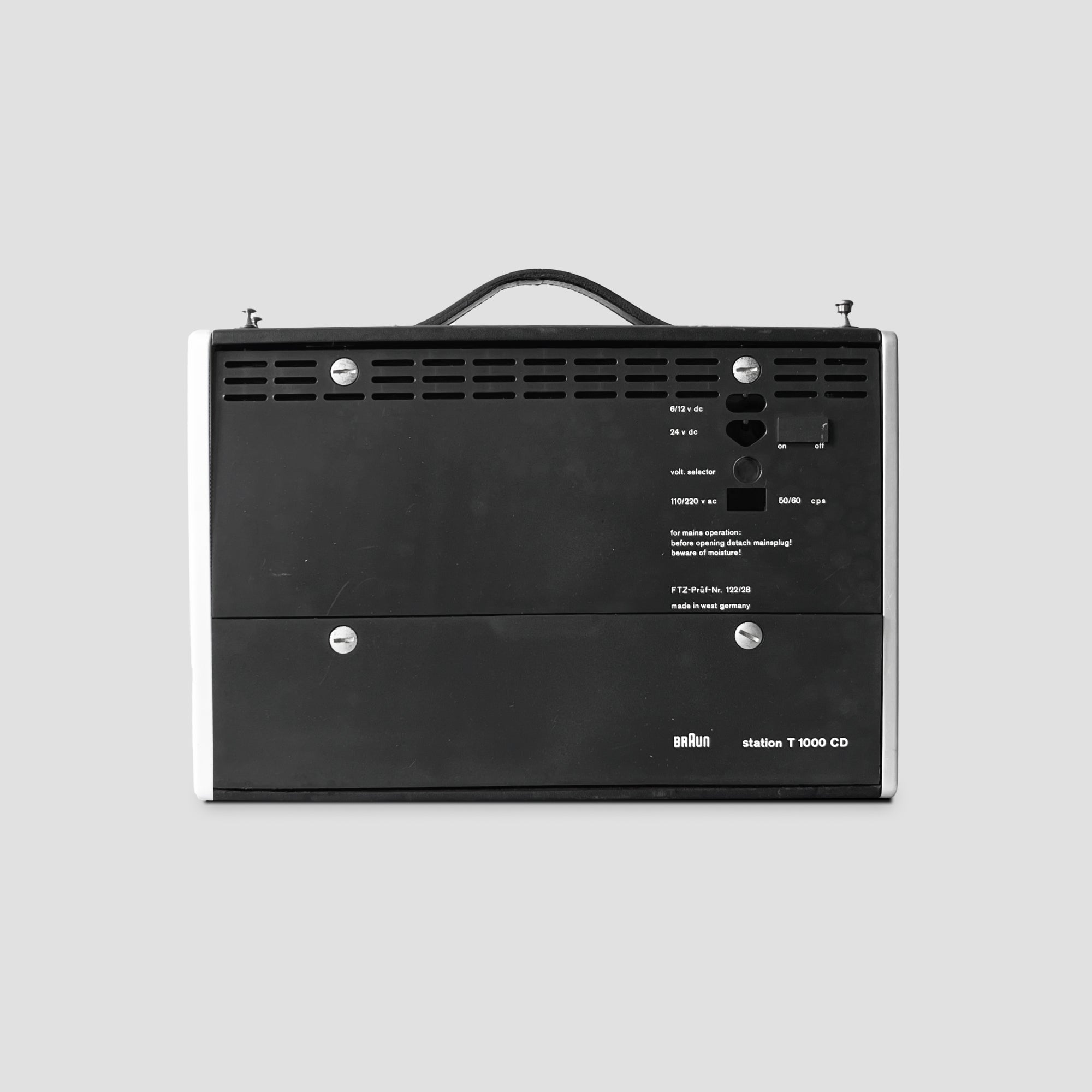 Braun T1000 CD retro radio with leather strap handle, showing front view.