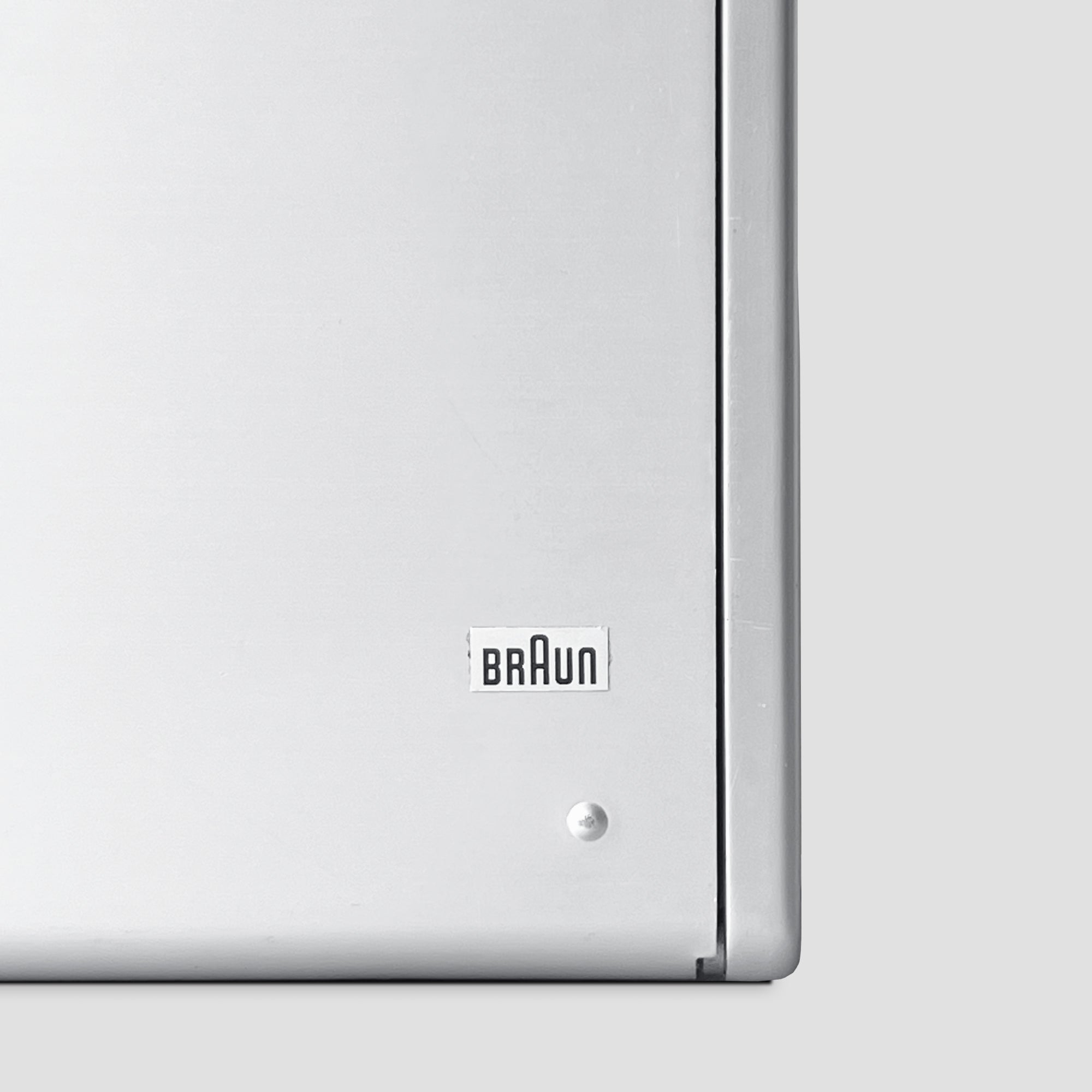 Close-up of the sleek tuning knob on the Braun T1000 CD vintage radio.