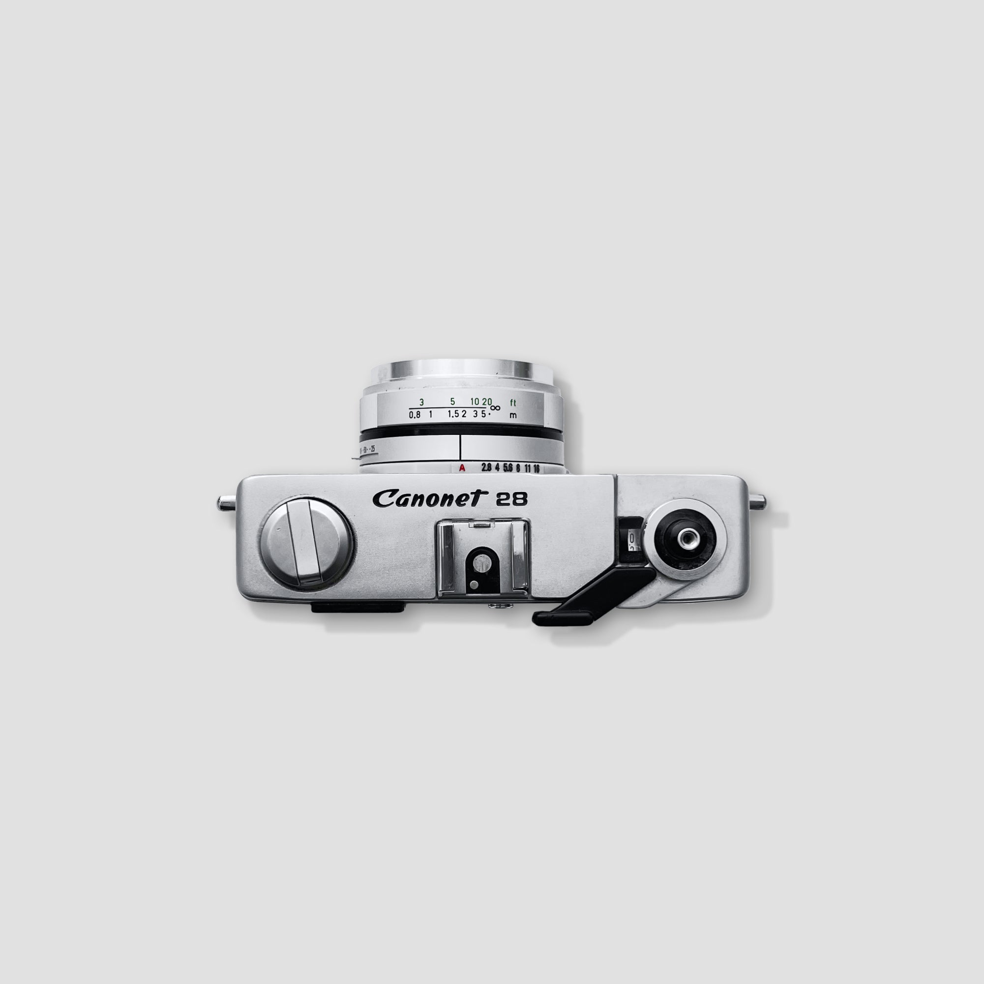 Canonet 28 camera in use, capturing a scenic landscape.