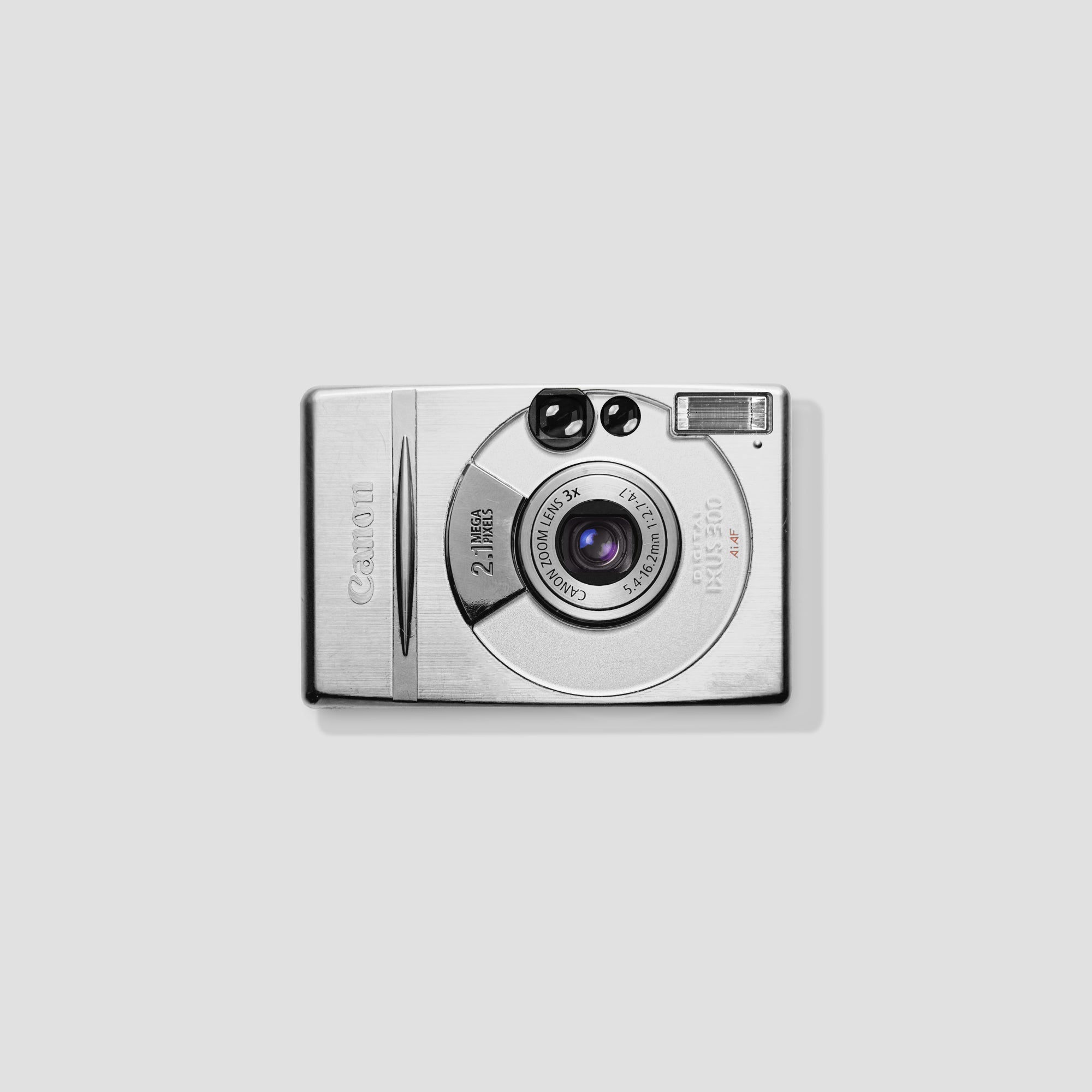 Canon IXUS 300 digital camera displaying its compact design and 3x zoom feature.