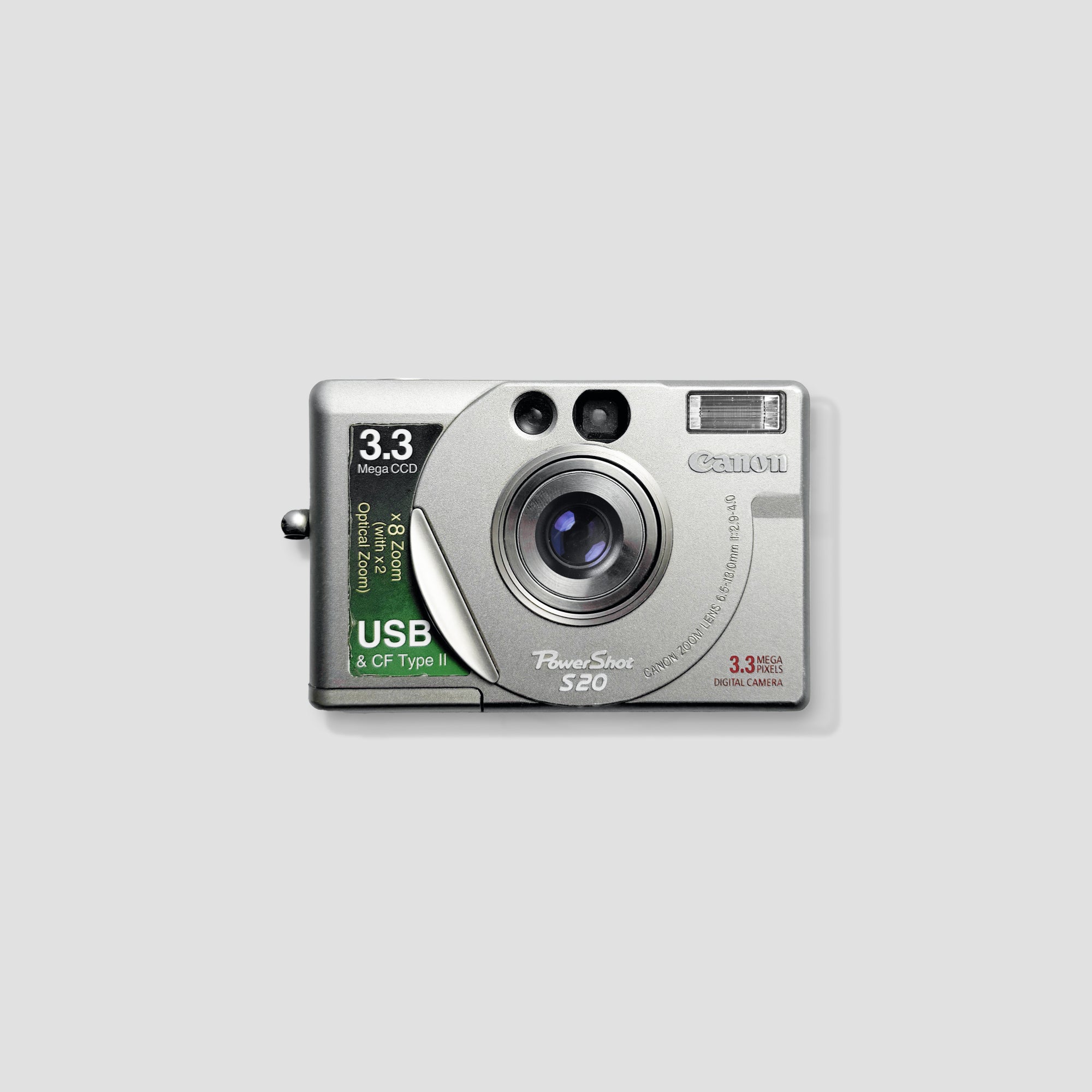 Canon PowerShot S20 compact digital camera showing 2x optical zoom in action.