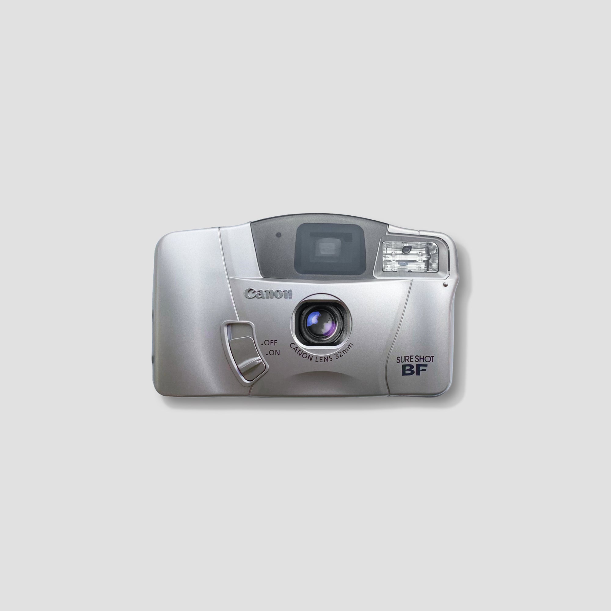 Close-up view of the Canon Sure Shot BF 35mm film camera highlighting its fixed-focus lens and automatic features.