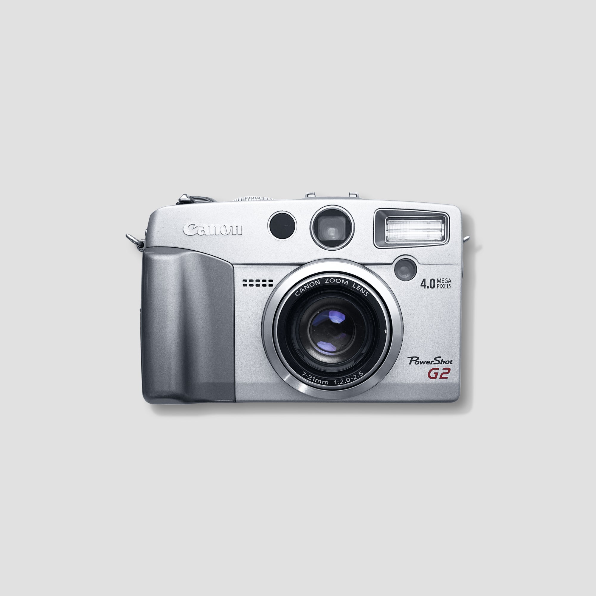 Canon PowerShot G2 camera from the front highlighting its compact size and manual mode dial