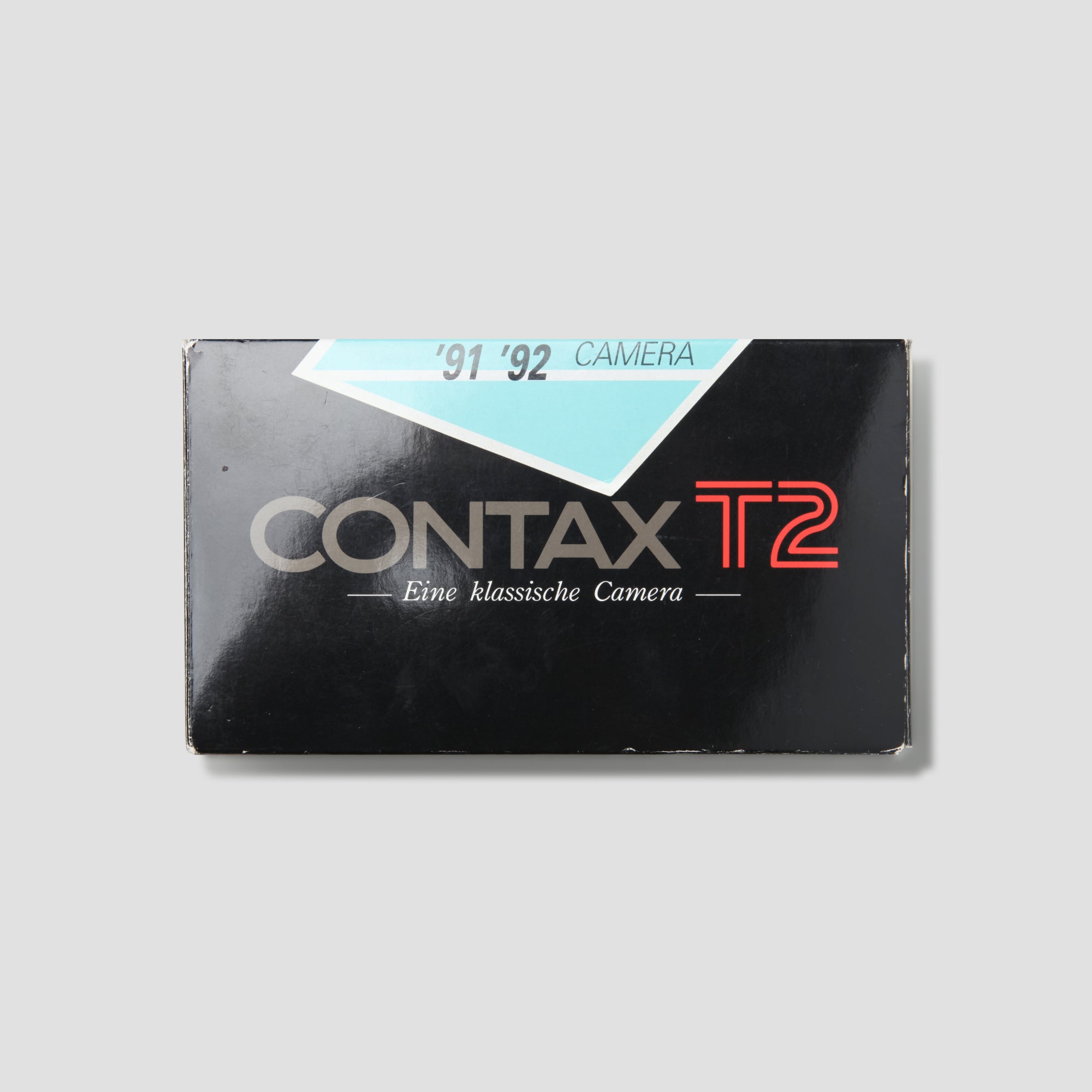 User  holding the Contax T2 film camera outdoors, capturing stunning images.