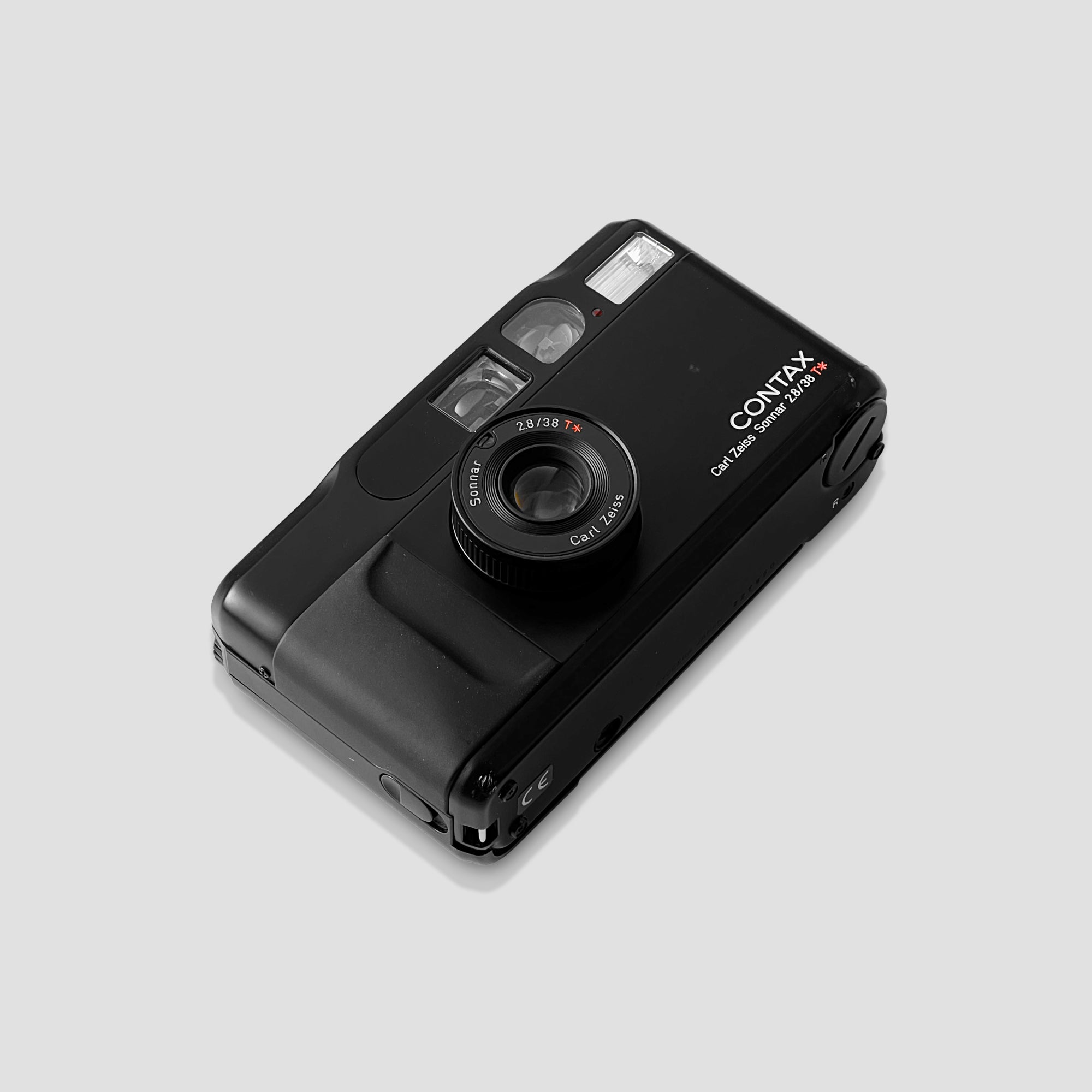 User  holding the Contax T2 film camera outdoors, capturing stunning images.