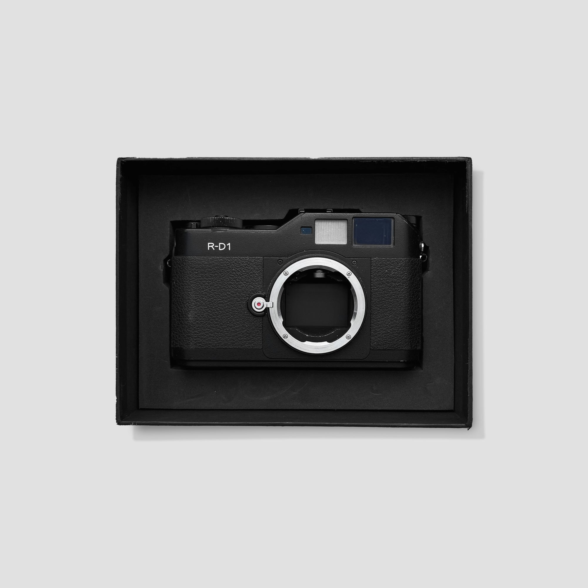 Close-up of the Epson R-D1 showing its mechanical shutter cocking lever and controls.