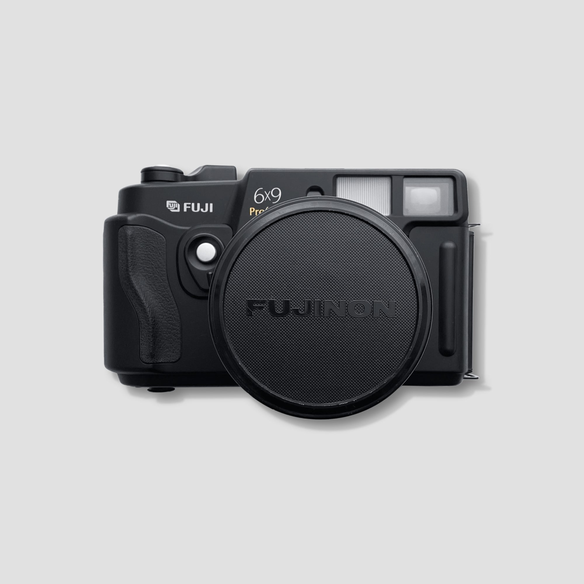 Close-up of Fujinon GW690 lens showing manual aperture control and rangefinder alignment.