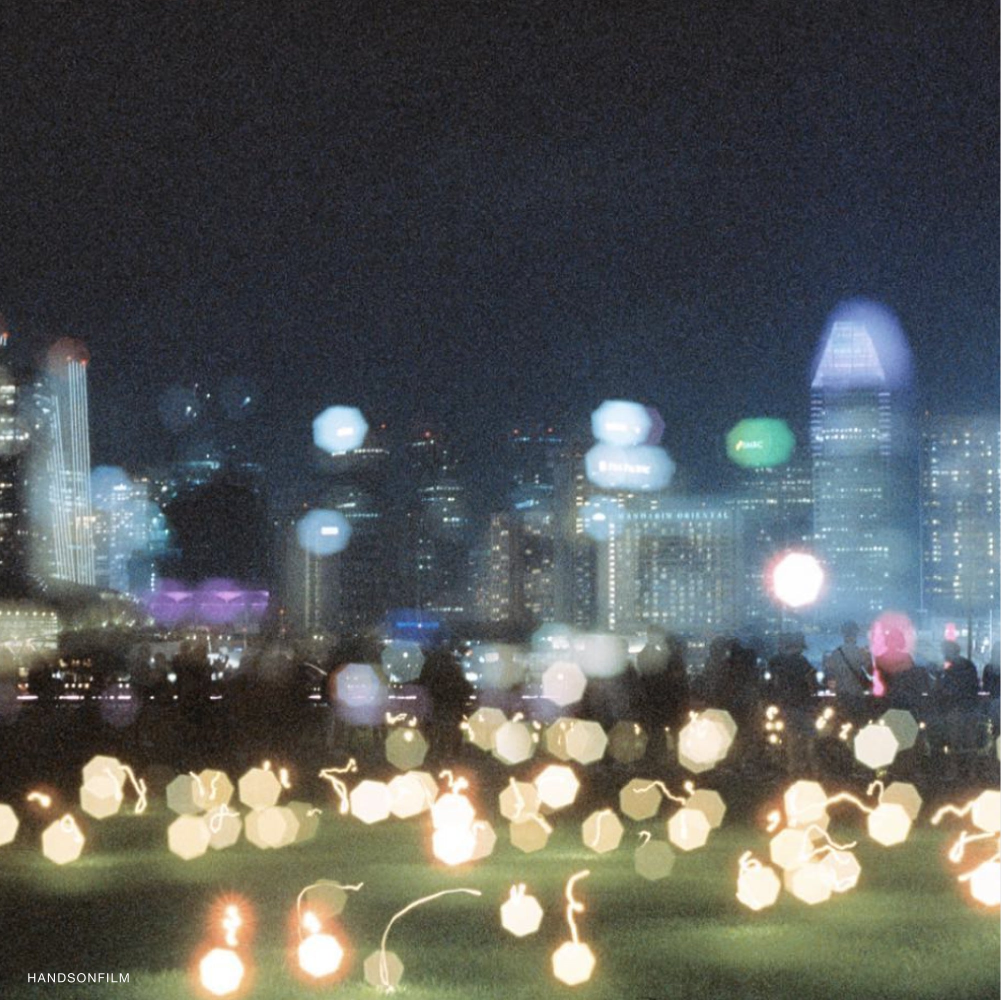 Photographer using 35mm camera with Midnight 1600 film during nighttime