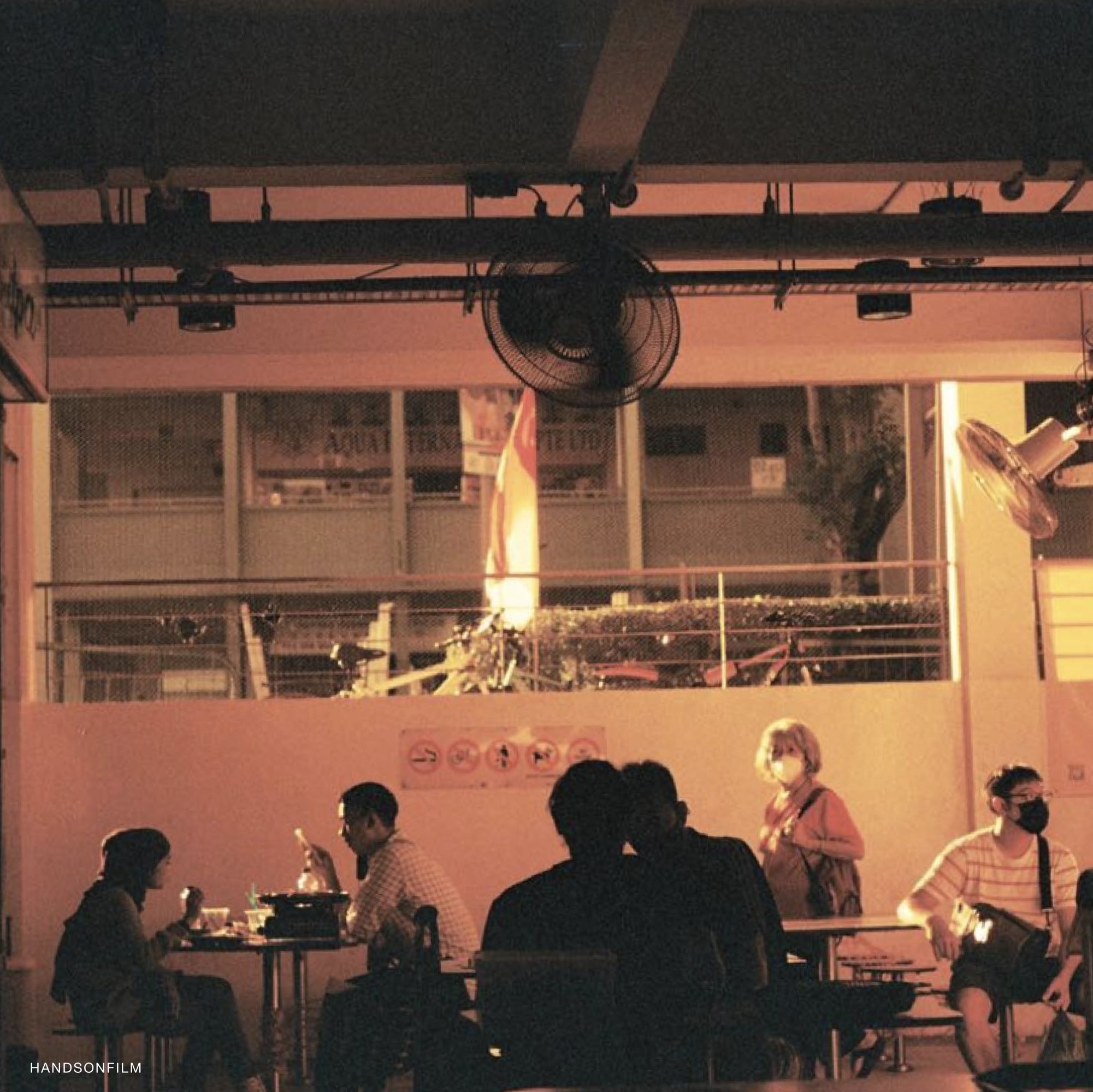 Photographer using Vivid RedScale 400 Film in a 35mm camera to capture warm, nostalgic scenes.