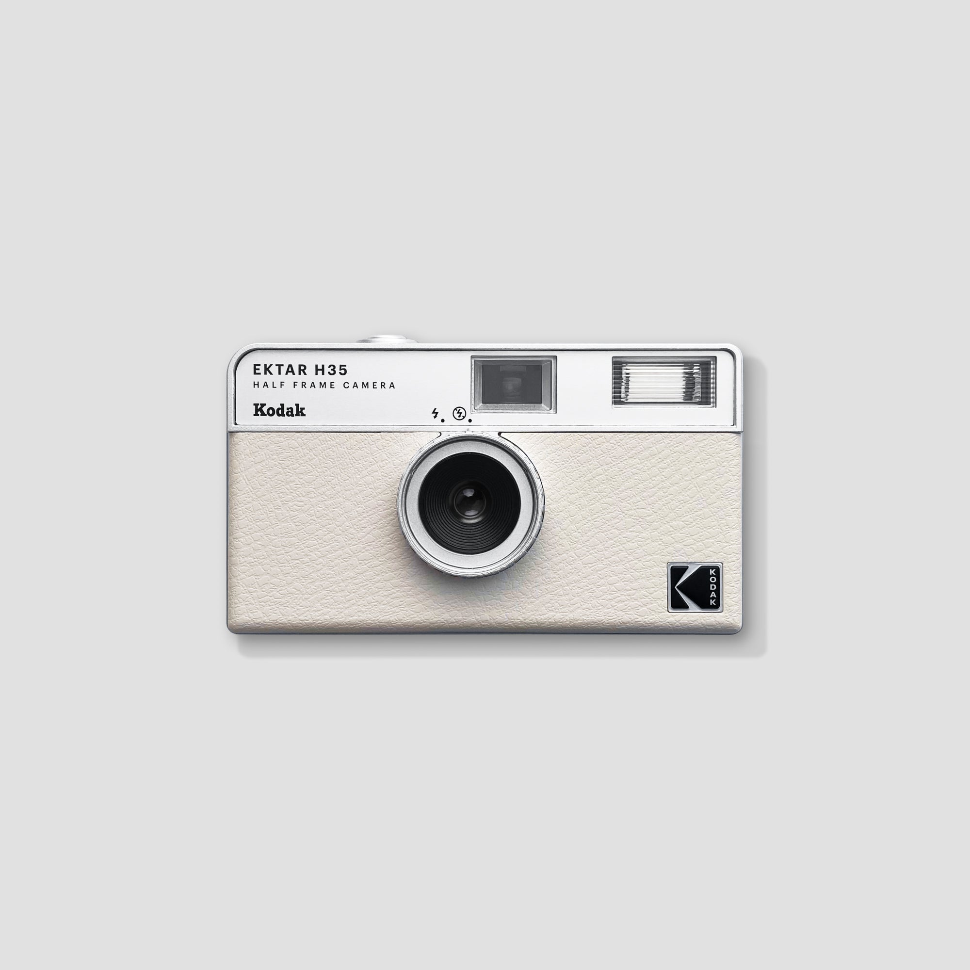 Close-up of Kodak Ektar H35 White compact film camera showing manual film advance knob
