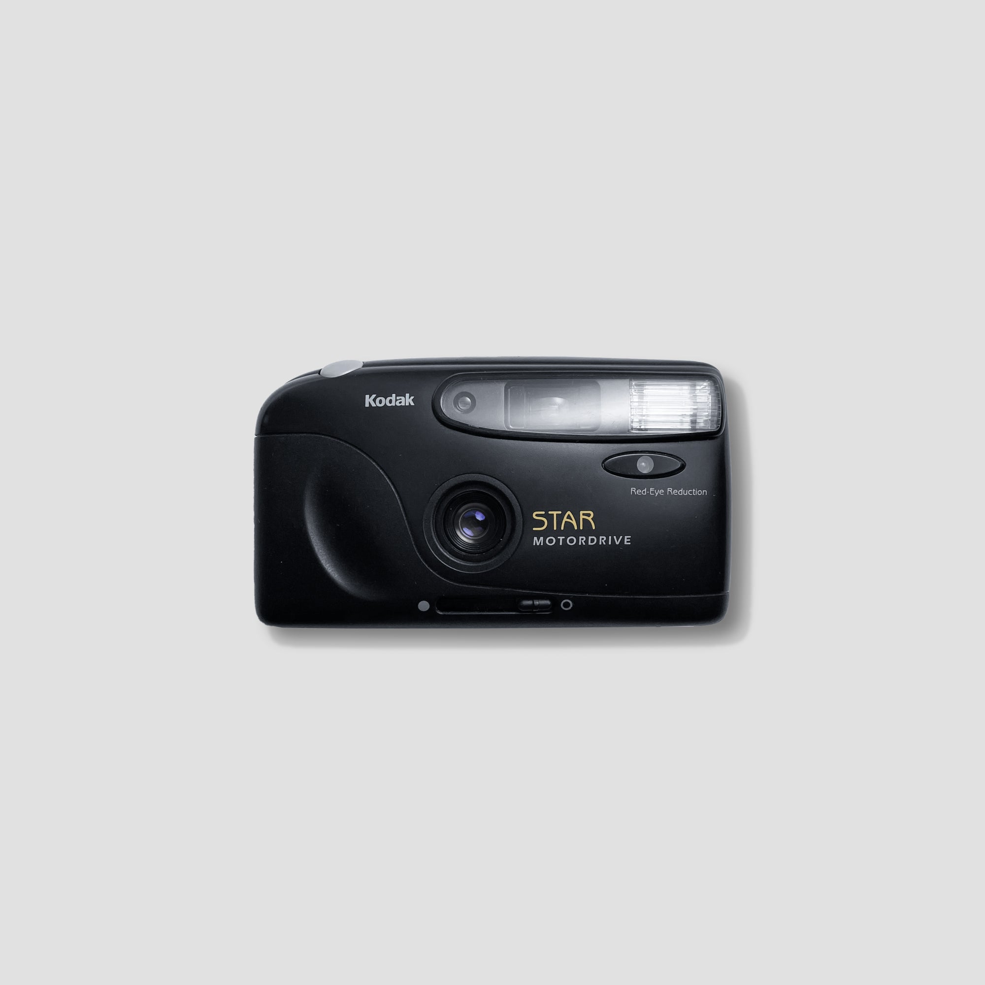 Close-up of Kodak Star Motordrive film camera, highlighting its 35mm lens and vintage design.