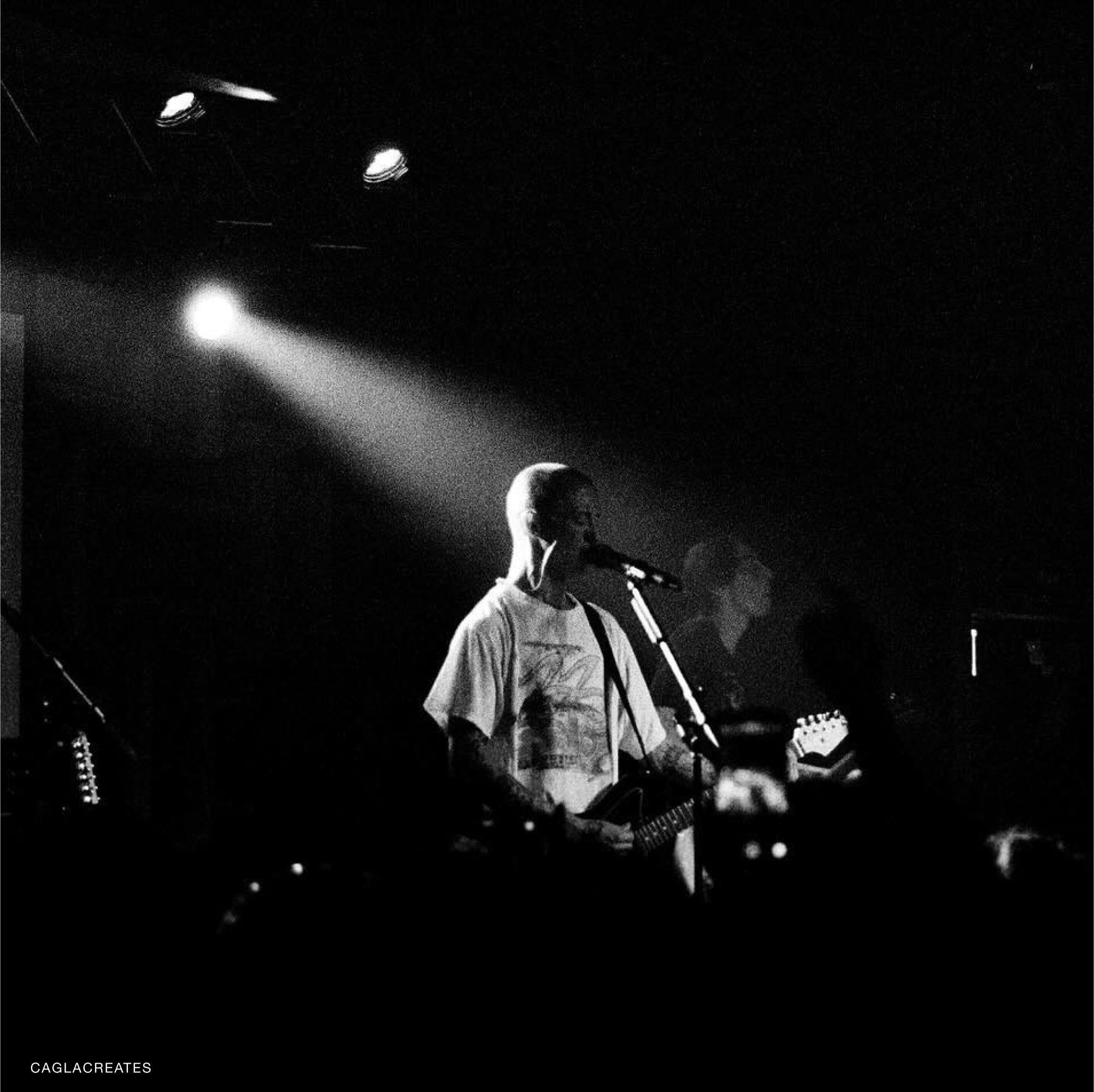 Kodak T-Max P3200 film in a photographers hand, ideal for capturing gritty street scenes with fine grain texture.