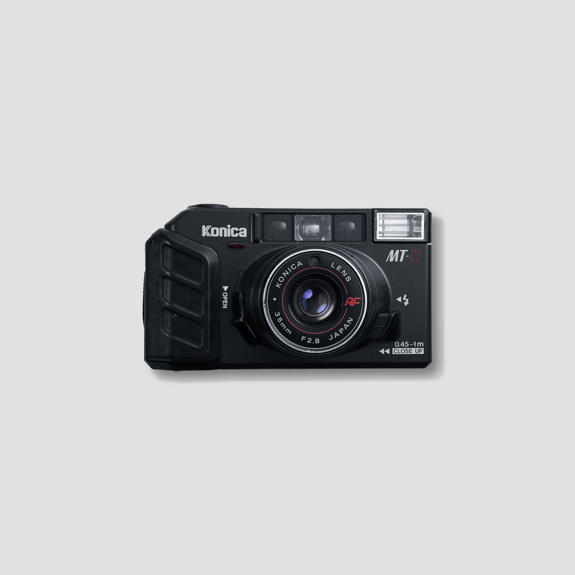 Side view of the Konica MT-11 vintage point and shoot camera, highlighting its compact design.