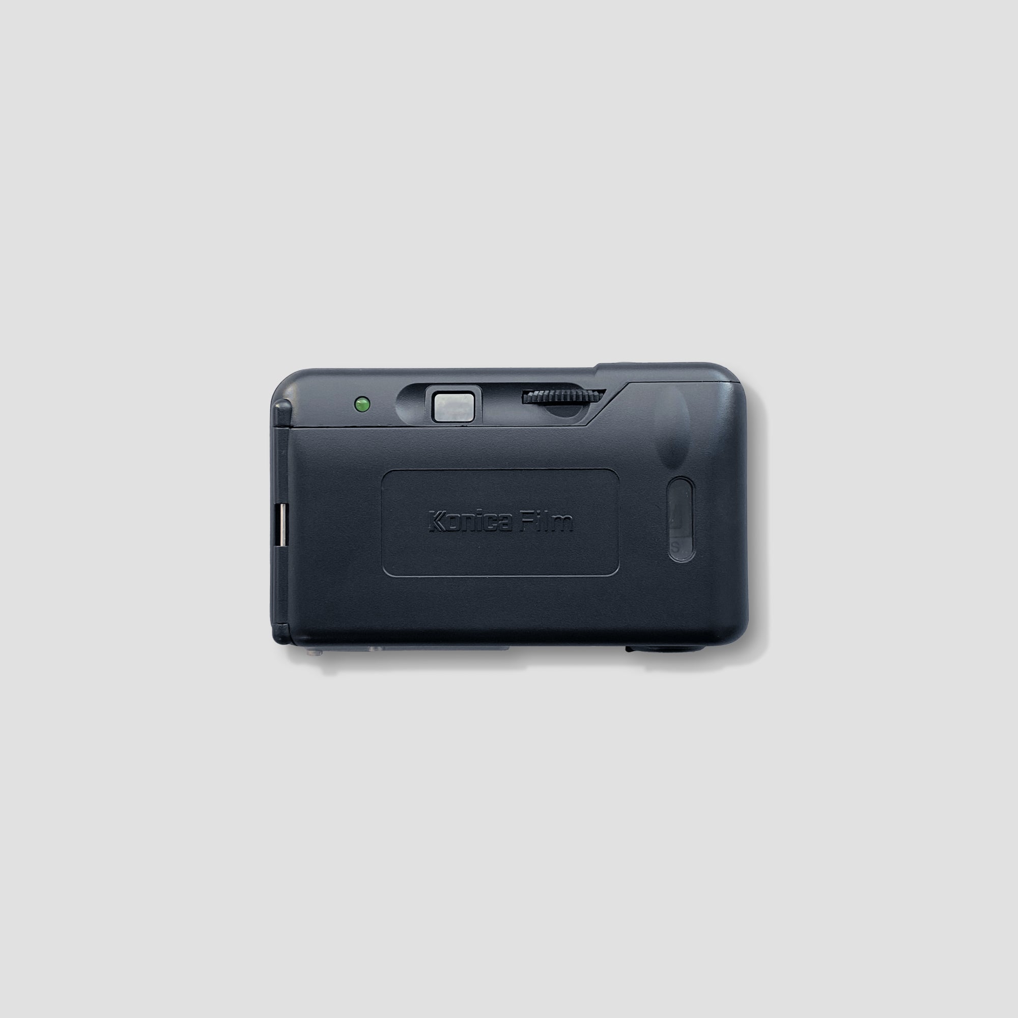 Close-up of the Konica Pop Mini displaying its controls and battery compartment.