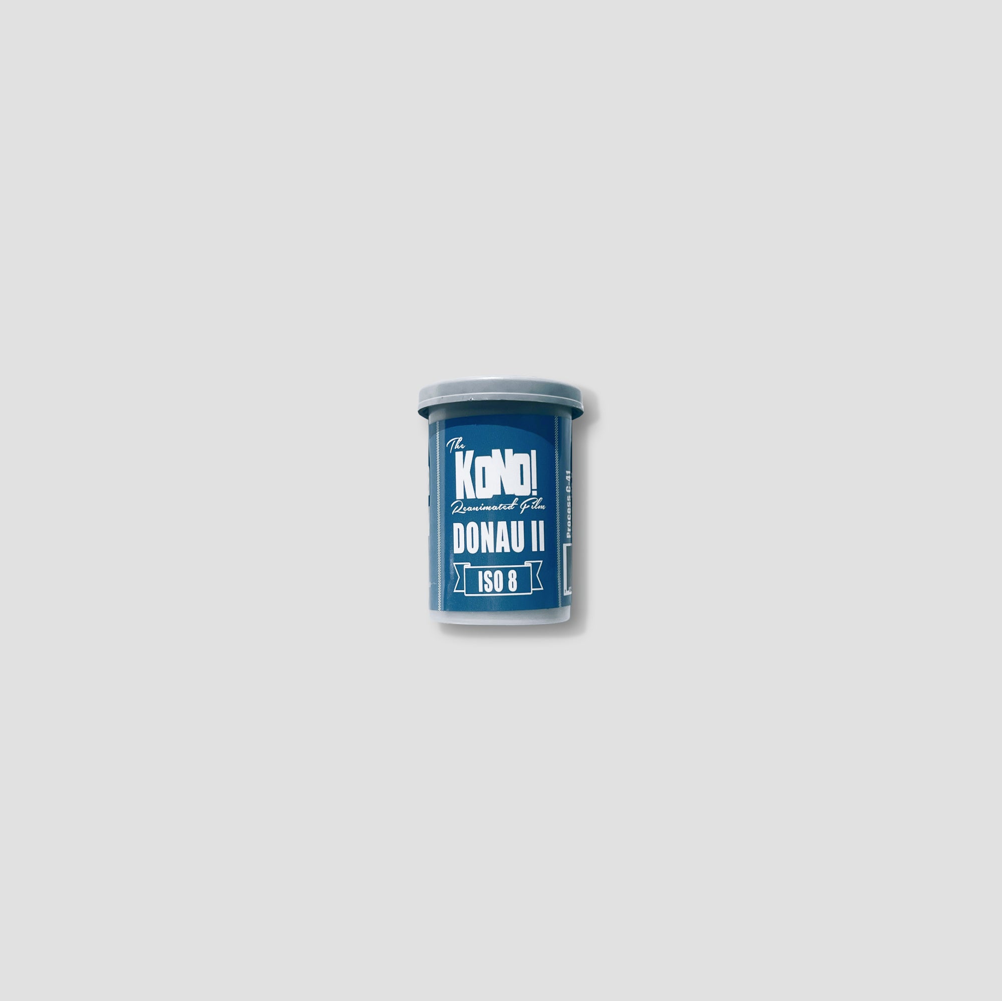Kono! Donau II film roll against a picturesque sunset, highlighting its blue and purple tones for stunning landscapes.