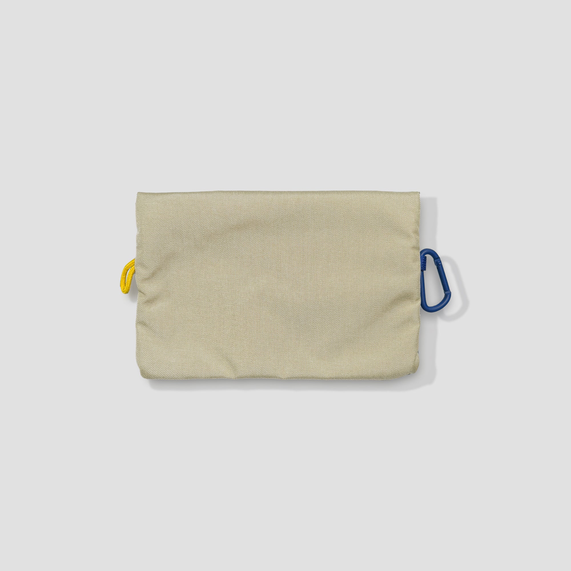 Compact photo pouch with carabiner attached to a backpack
