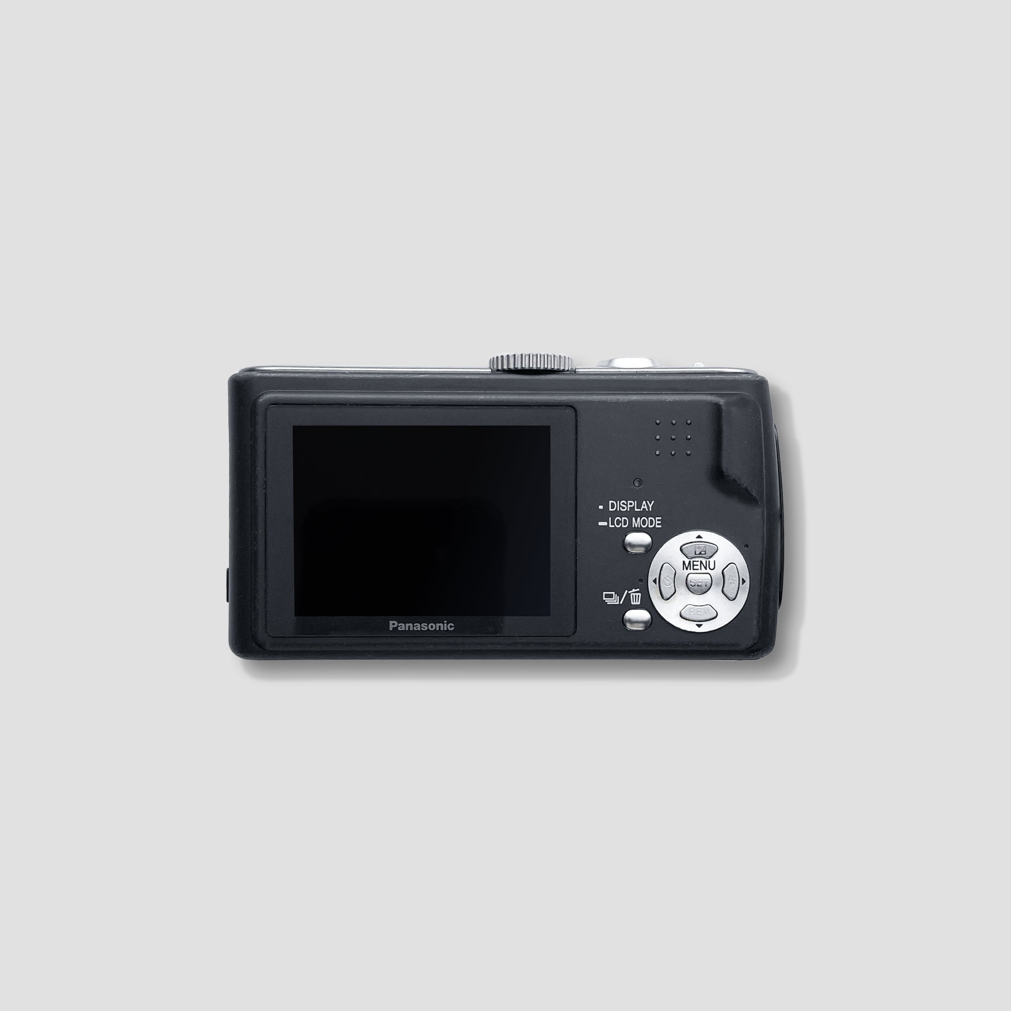 Side angle of the Panasonic Lumix DMC-TZ1 with a scenic background, demonstrating its portability for vacations