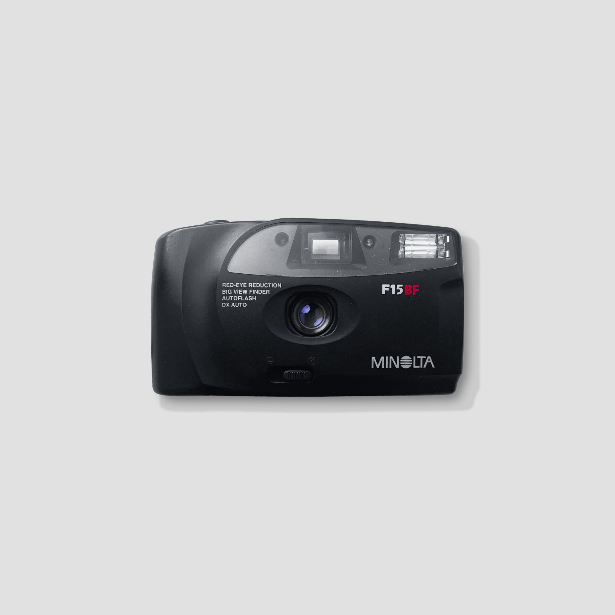 Close-up view of Minolta F15BF vintage 35mm film camera with flash.
