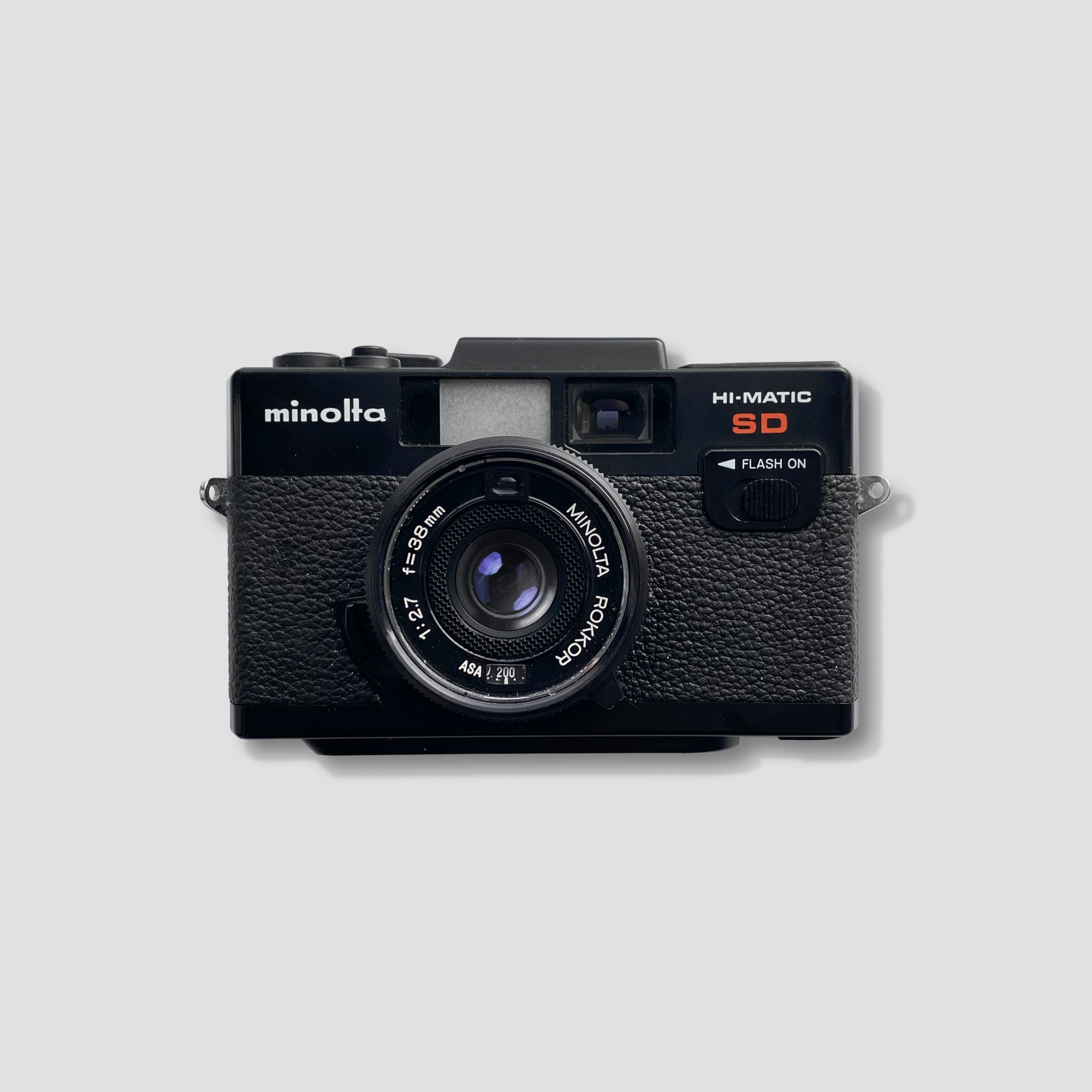 Minolta Hi-Matic SD rangefinder camera with vintage design and 35mm film roll