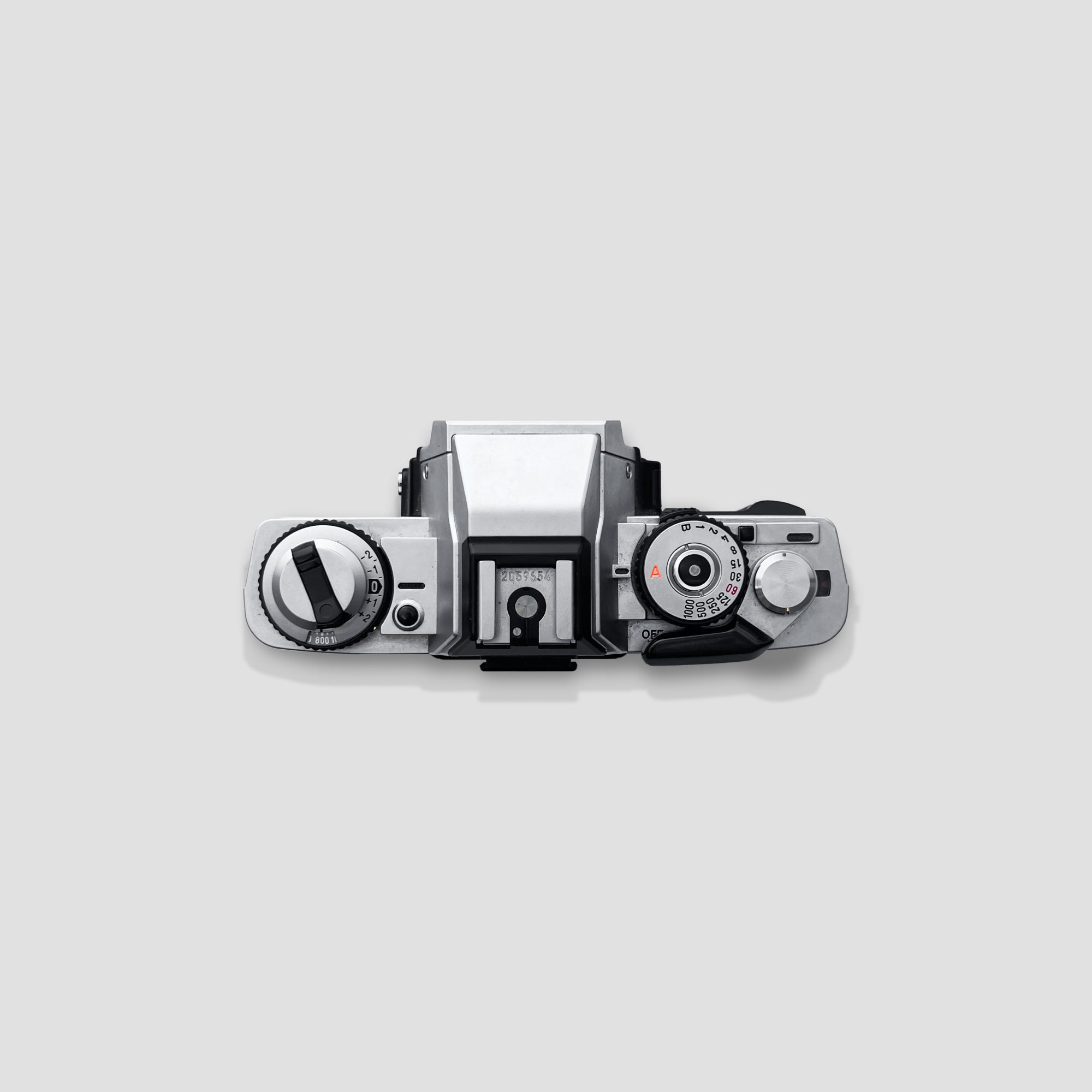 Minolta XG-M camera with starter lens, demonstrating its compact design and usability for photography.