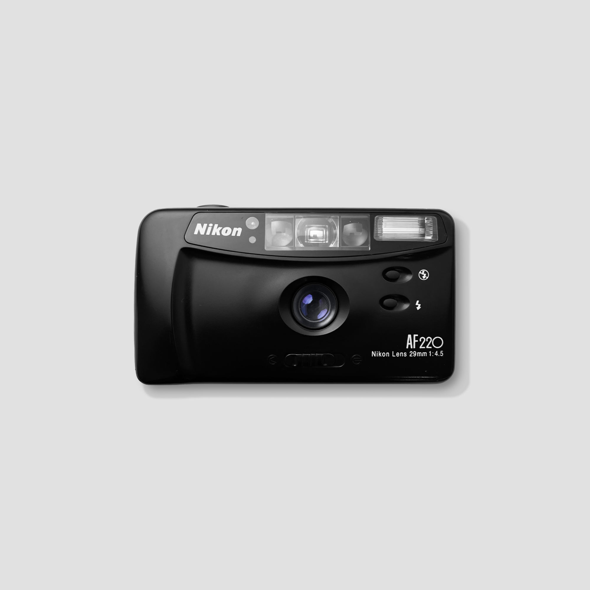 Close-up of Nikon AF 220 compact film camera showing the macro lens