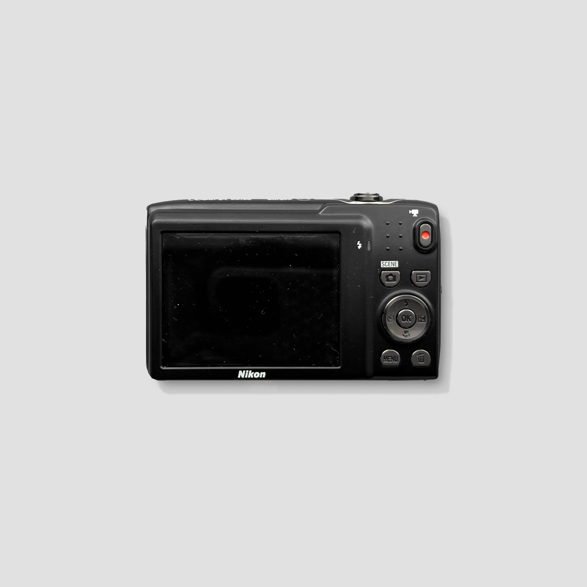 Nikon Coolpix S3100 in a stylish setting, showcasing its compact design for travel convenience.