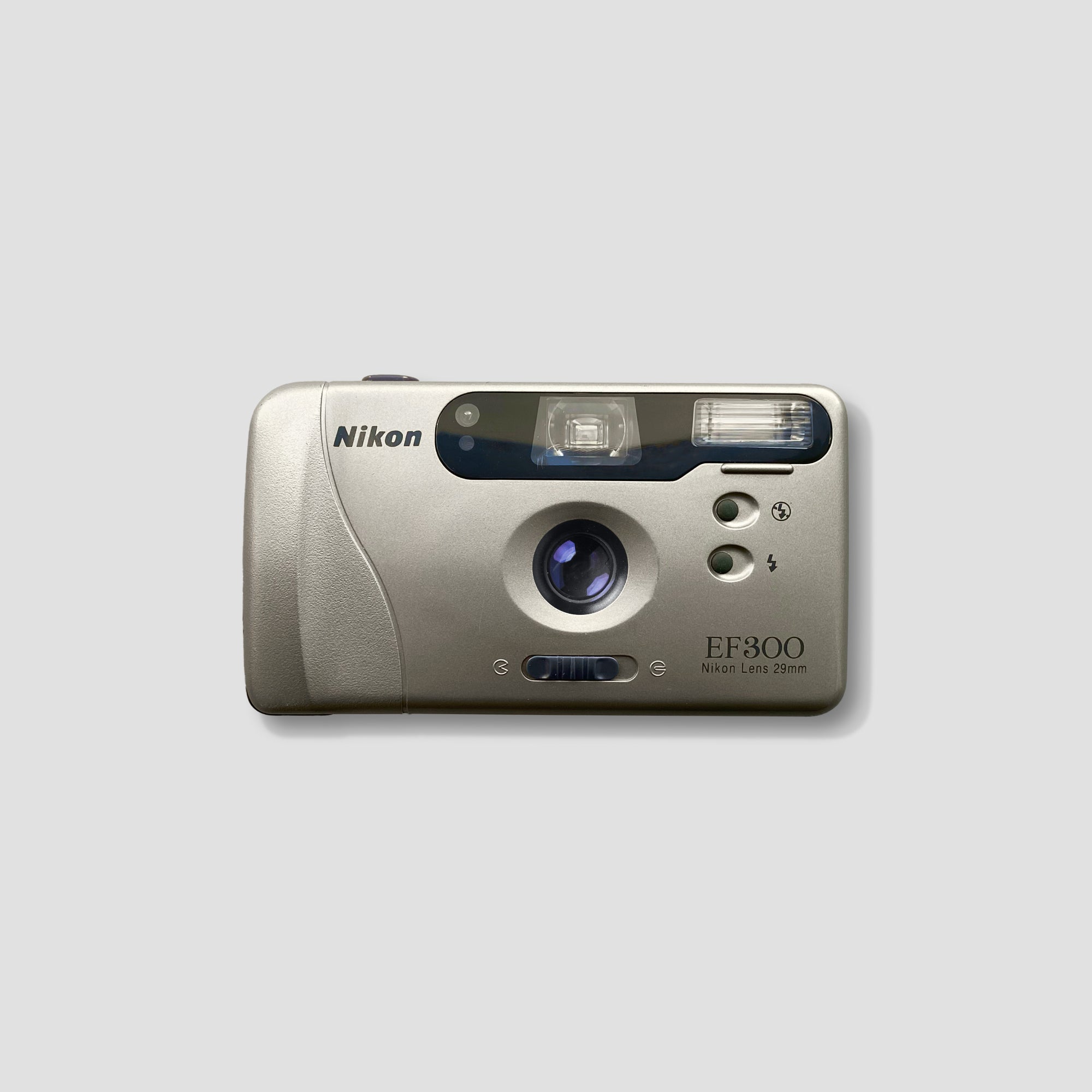 Nikon EF 300 vintage 35mm film camera from front angle, showing the champagne color and compact design