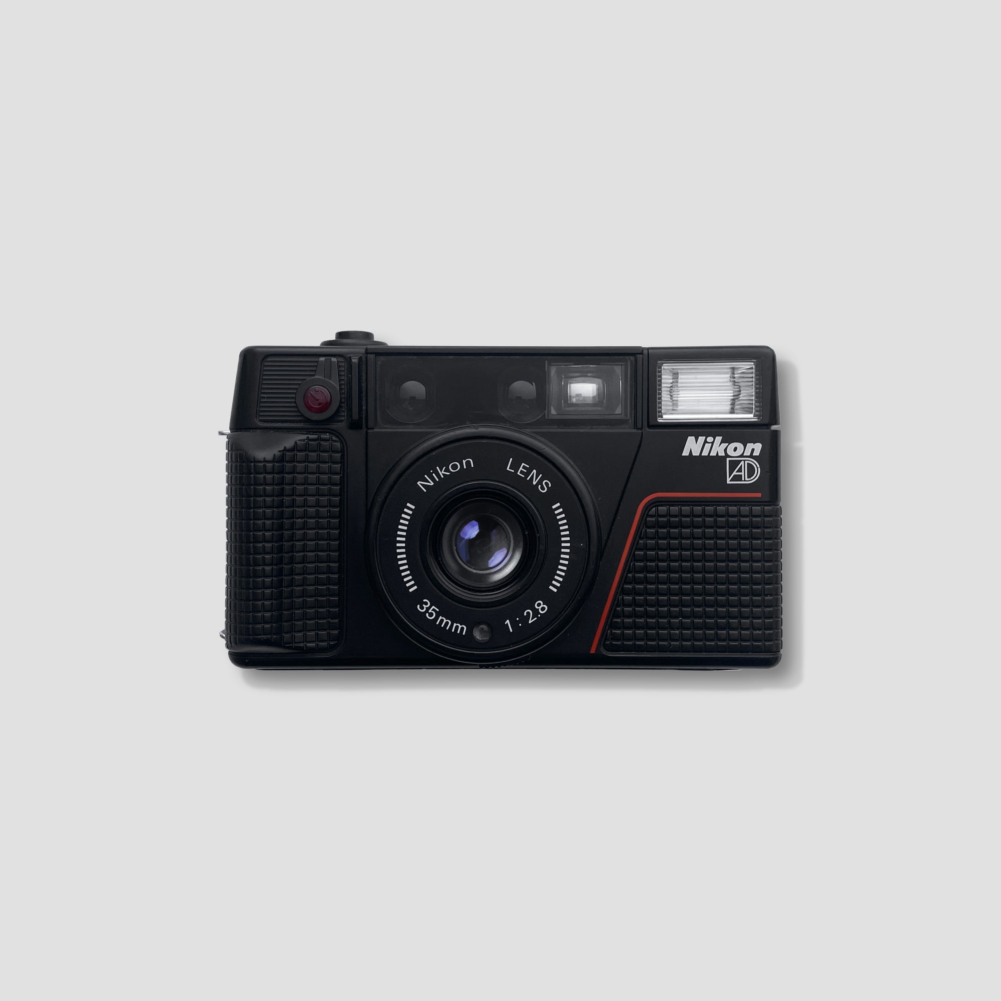 Nikon L35AD2 Compact Film Camera with a scenic background, ideal for casual photography.
