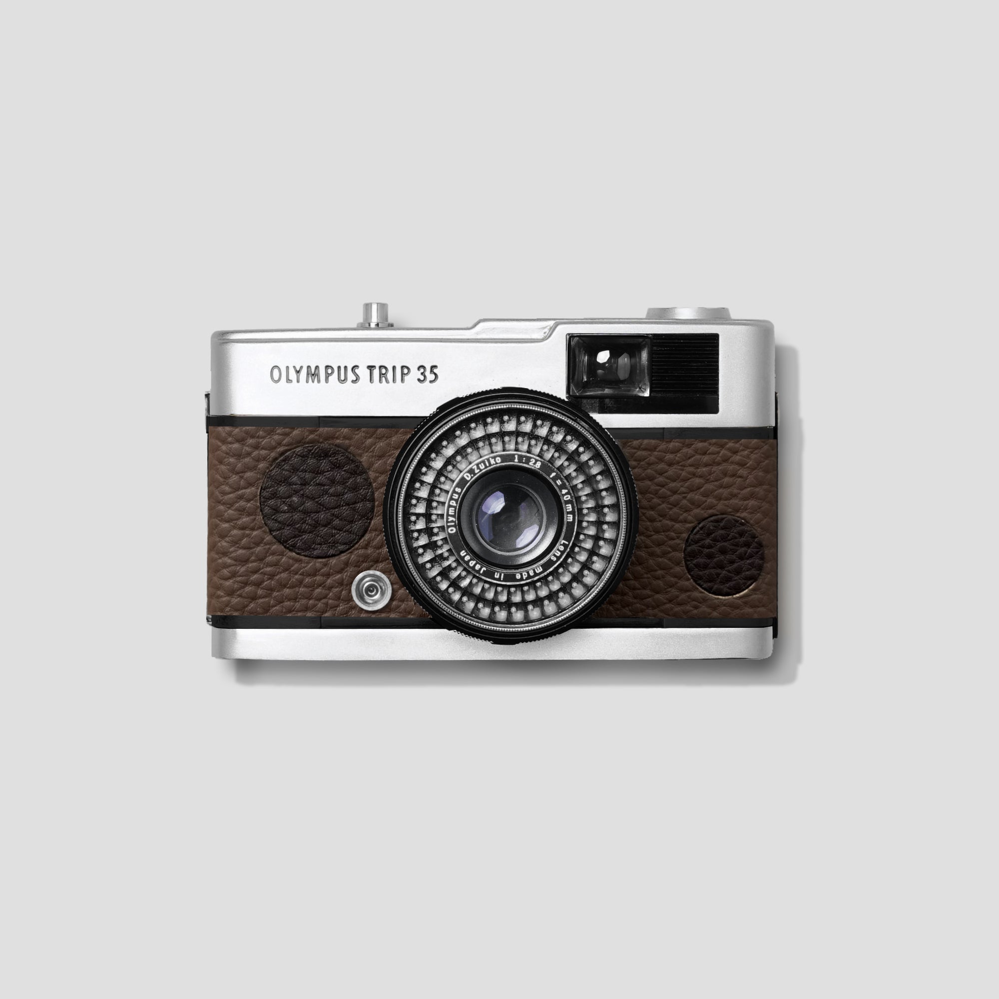 Olympus Trip 35 analog camera showcasing its custom leather exterior from a side angle.