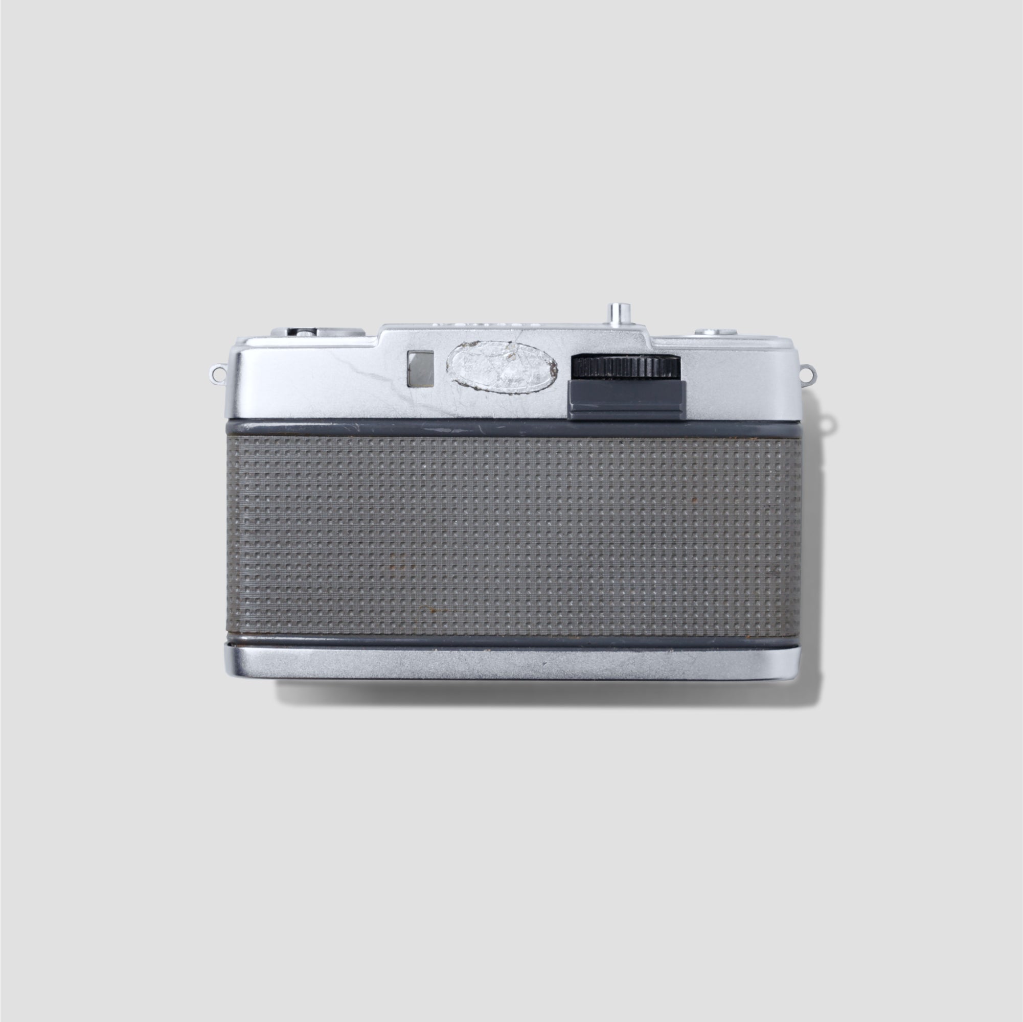 Olympus Pen-EE compact 35mm film camera from the front showing its sleek design