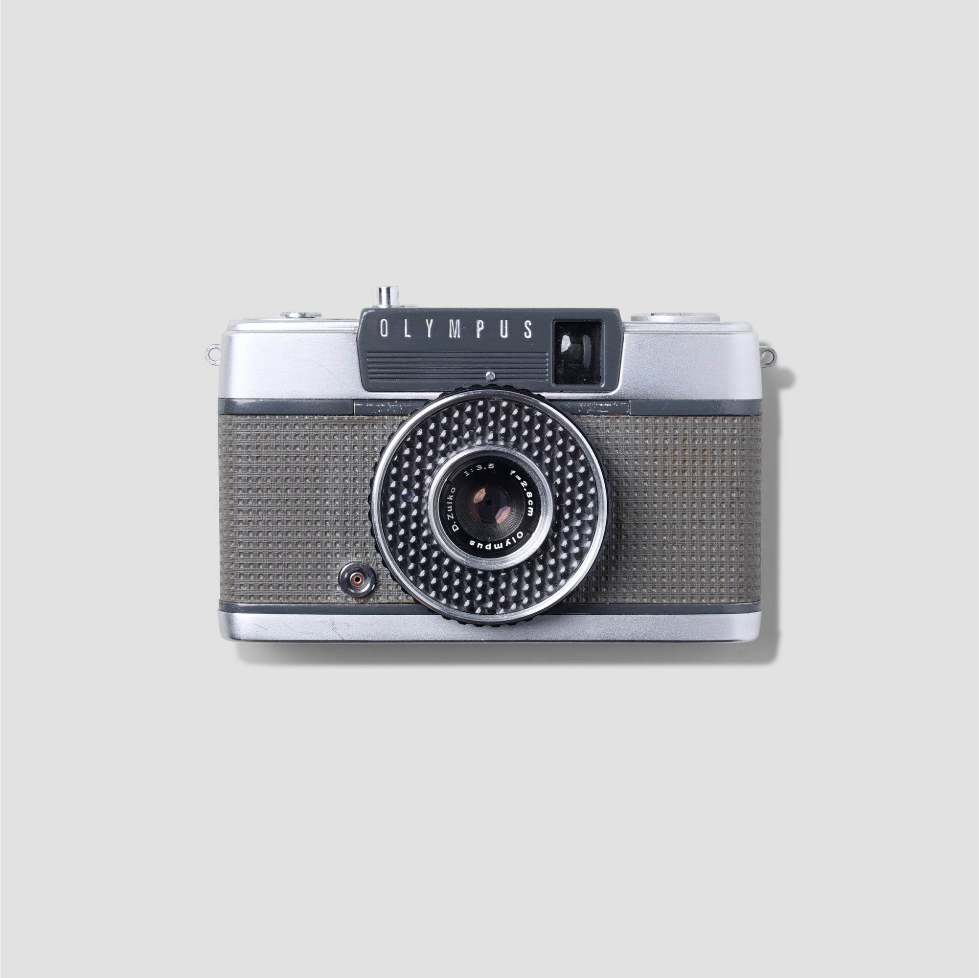 Olympus Pen-EE compact 35mm film camera from the front showing its sleek design