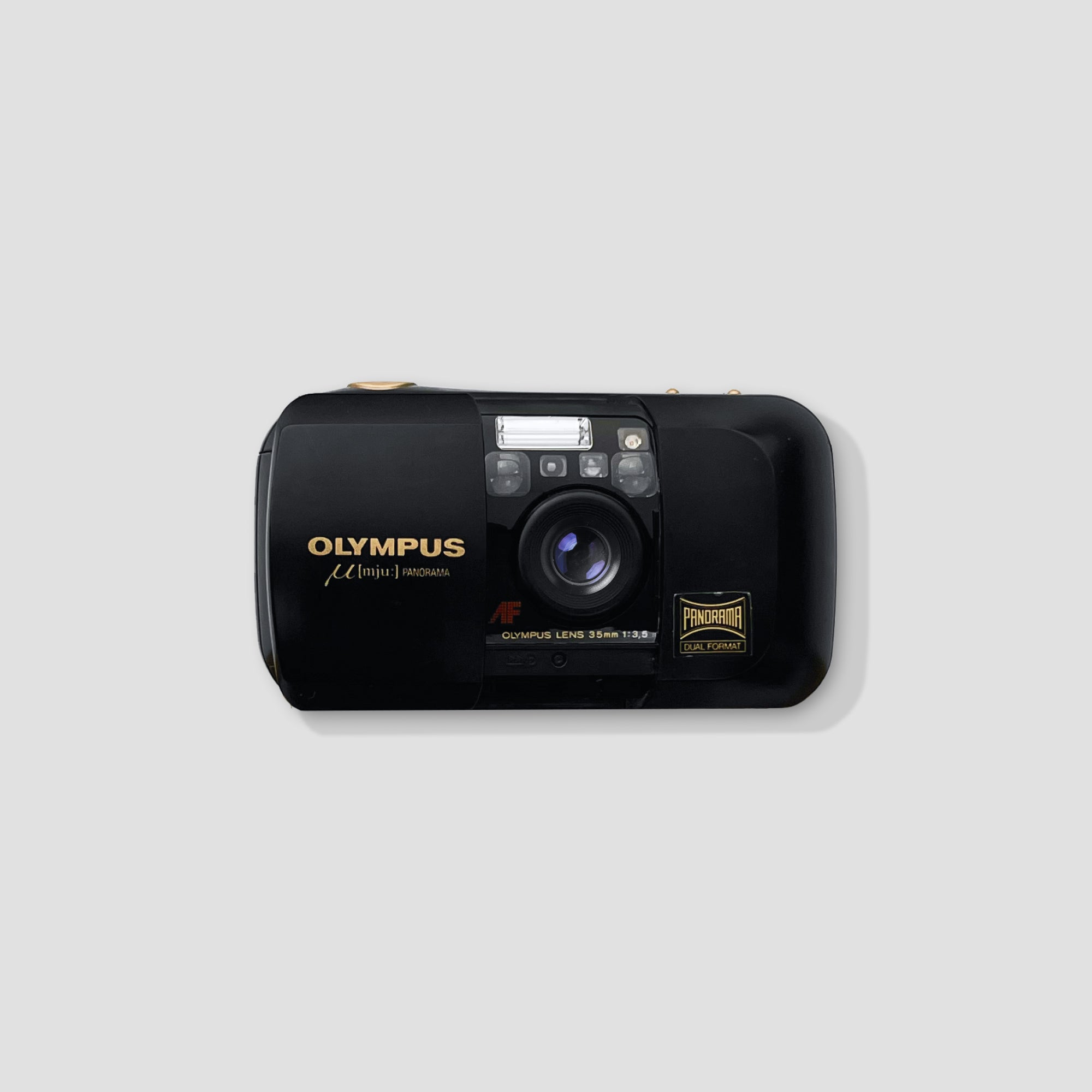 Olympus MJU Panorama Compact Camera in hand, perfect for travel photography.