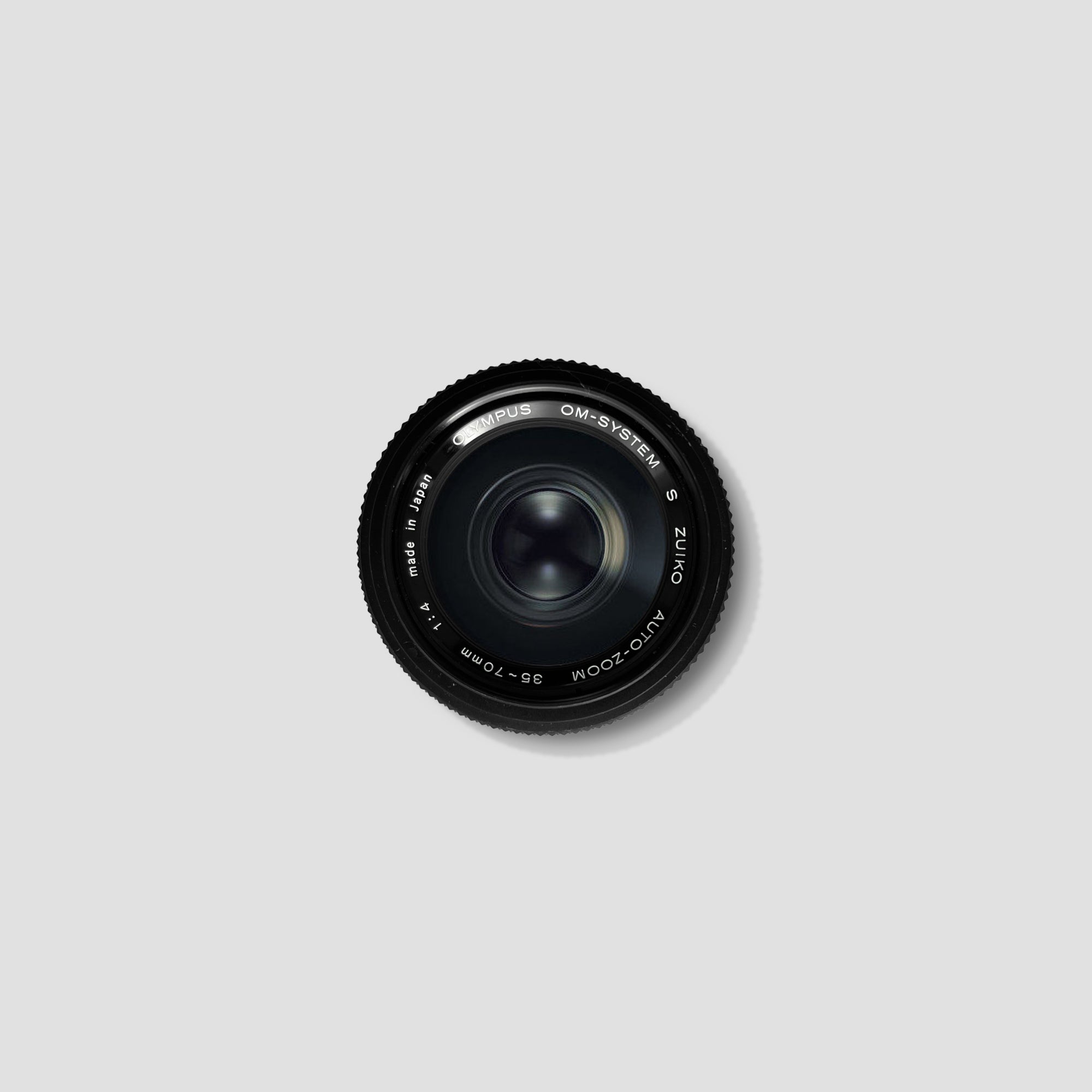 Olympus OM System 35-70mm lens showcasing its sleek design and compatibility with OM-mount cameras.