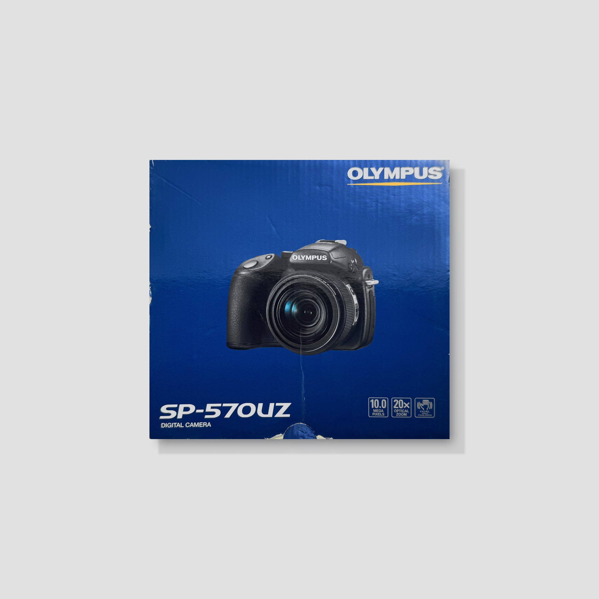 Olympus SP-570UZ bridge camera showing ergonomic design and grip.