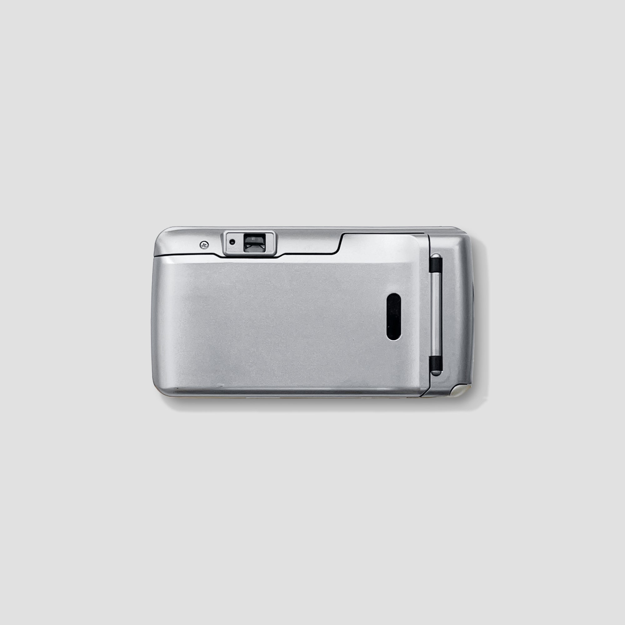 Close-up of the Olympus Superzoom 76s camera highlighting its controls and zoom lens for travel photography.