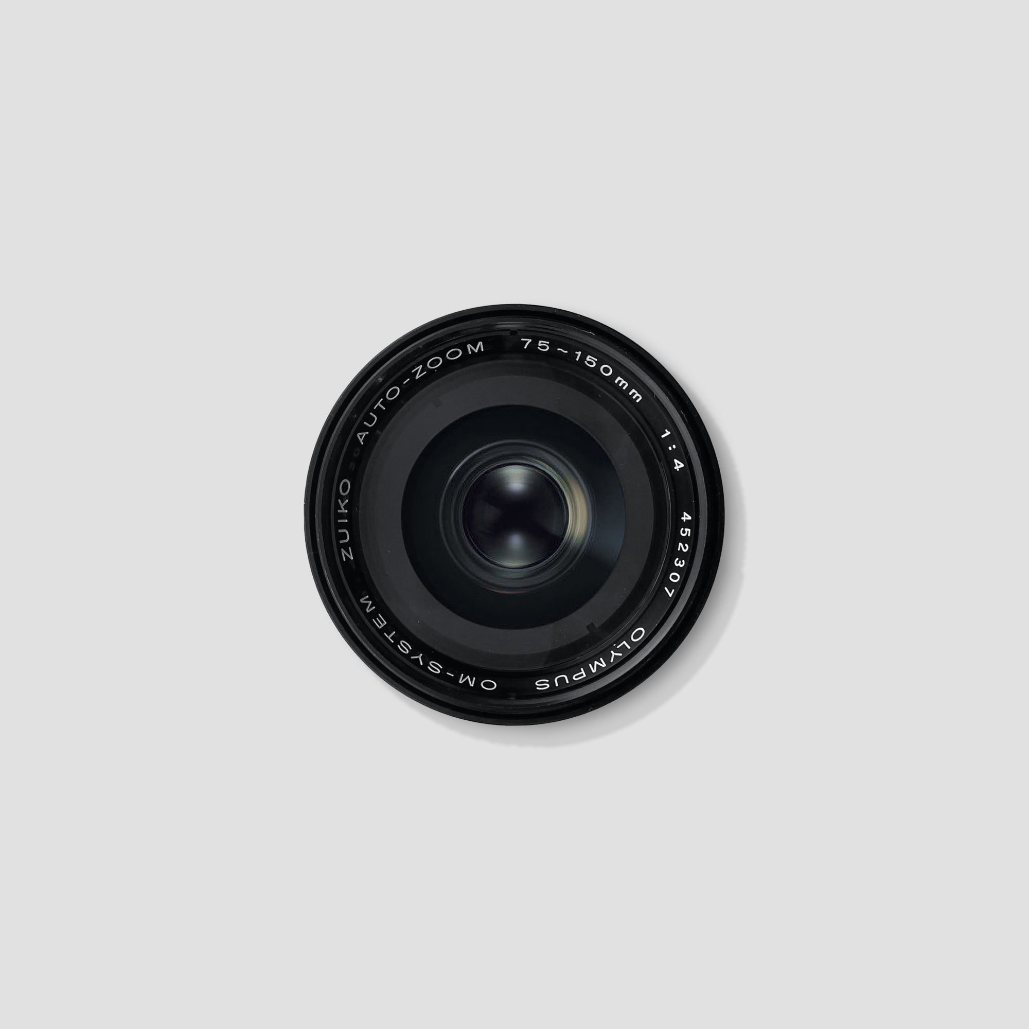 Close-up of Olympus OM System Zuiko 75-150mm f/4 lens showing focal length markings