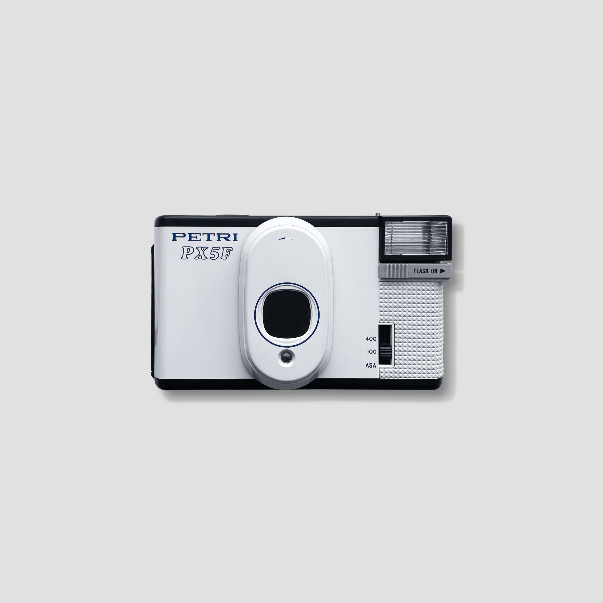 Close-up of the Petri PX5F showing its 33mm f/5.6 lens and controls.