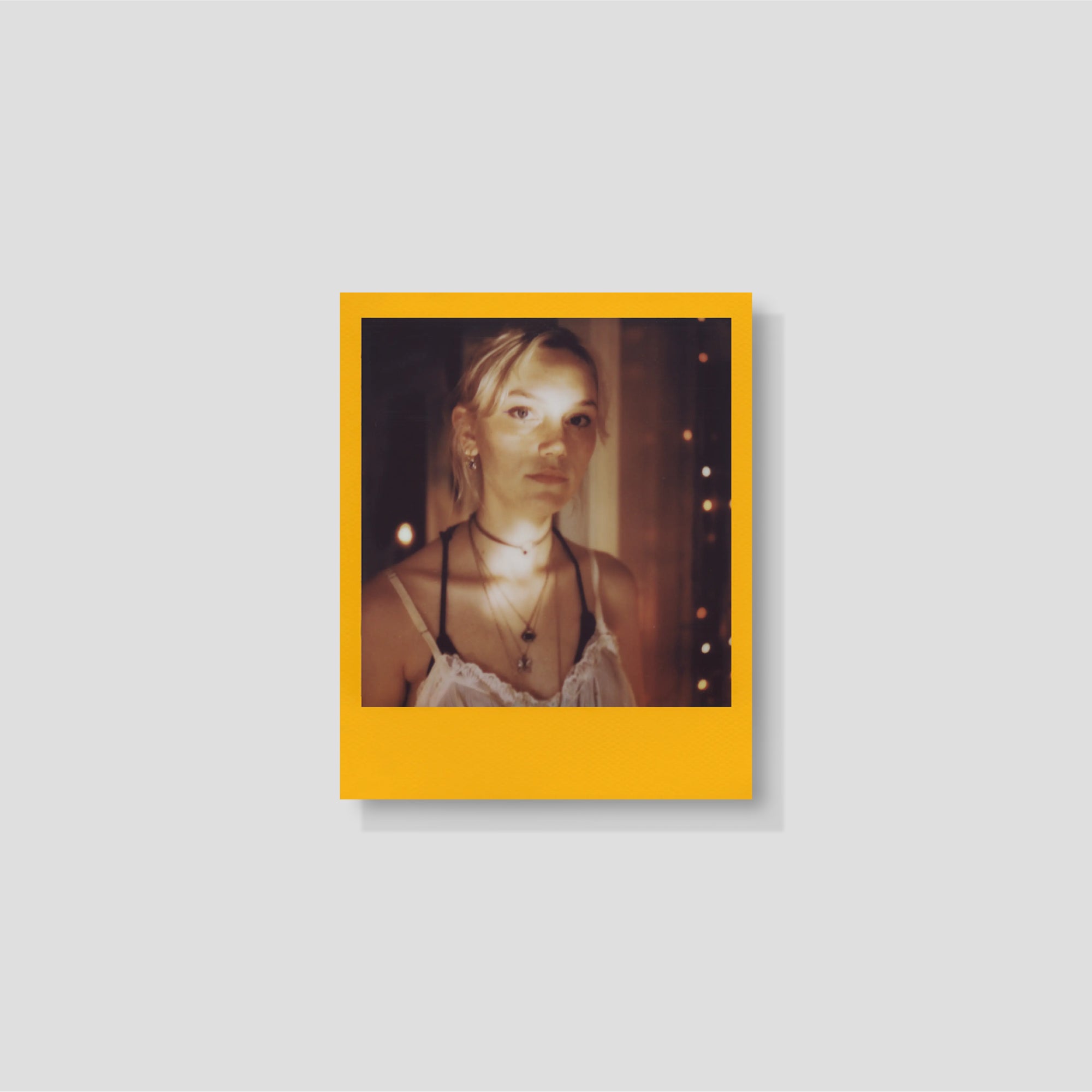 Polaroid camera loaded with 600 film, staged in cozy living space for instant memory-making