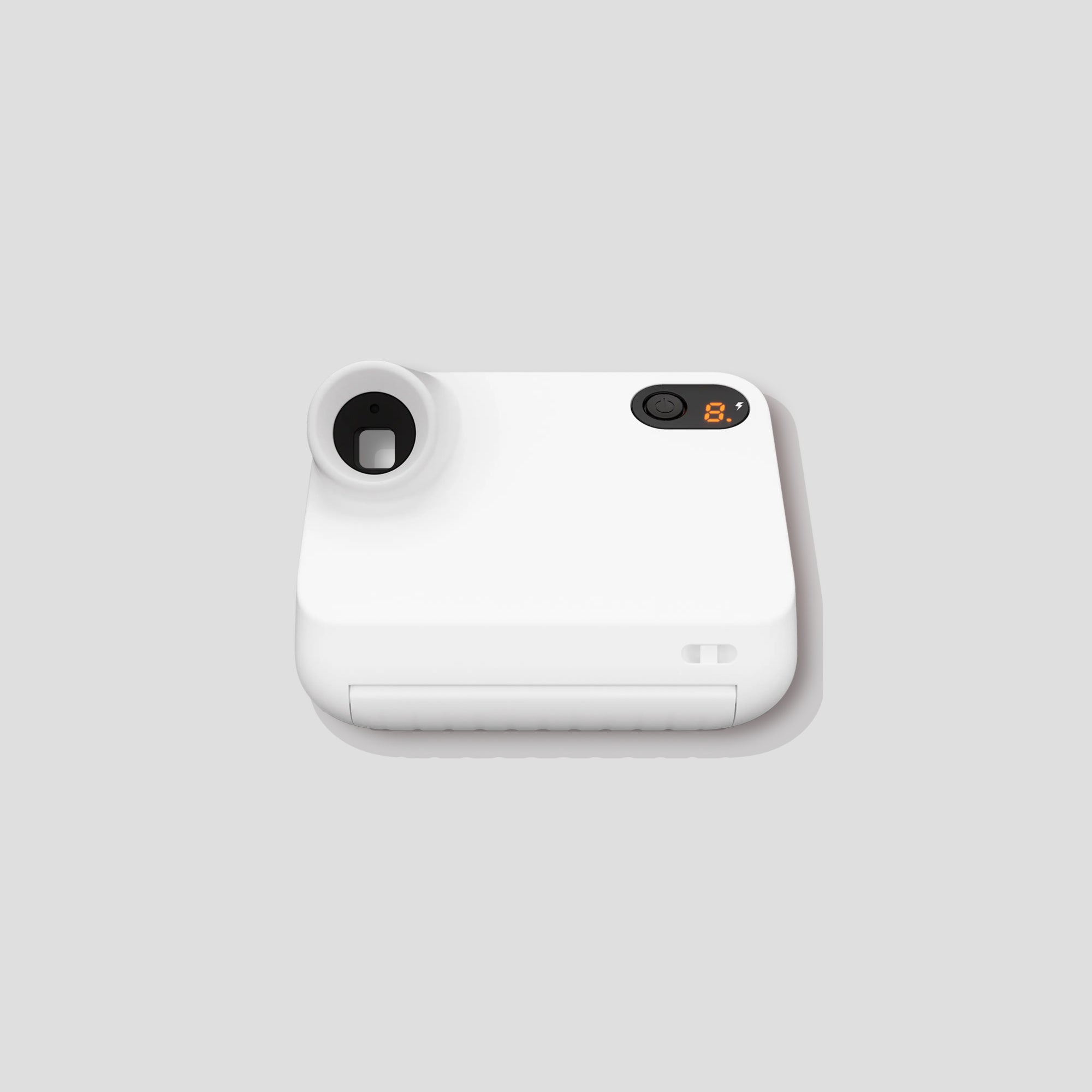 User  taking a selfie with the Polaroid Go 2 in a vibrant setting.