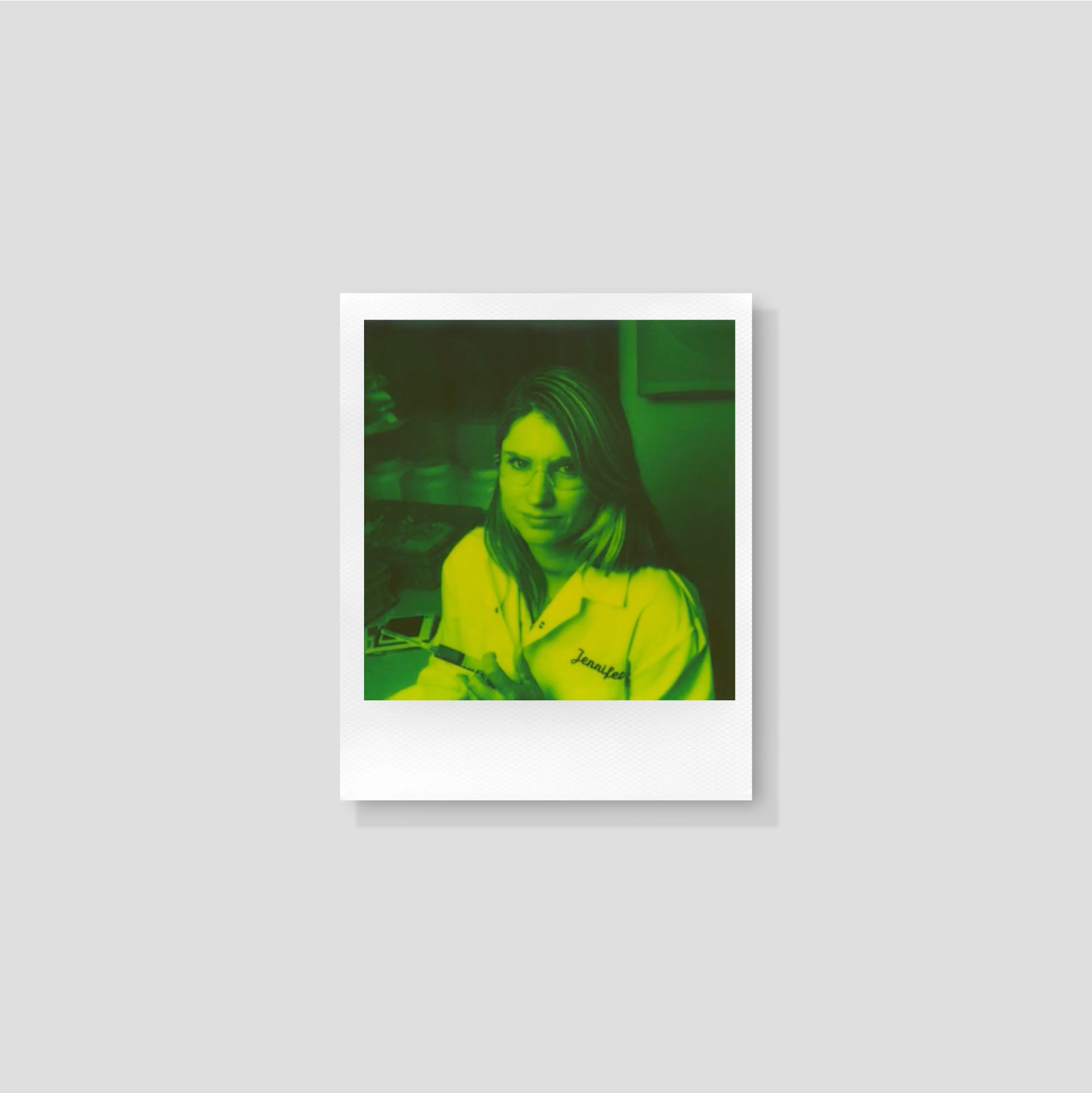 A Polaroid camera in action, utilizing Green 600 film to capture a moment outdoors, showcasing its instant photo capabilities.