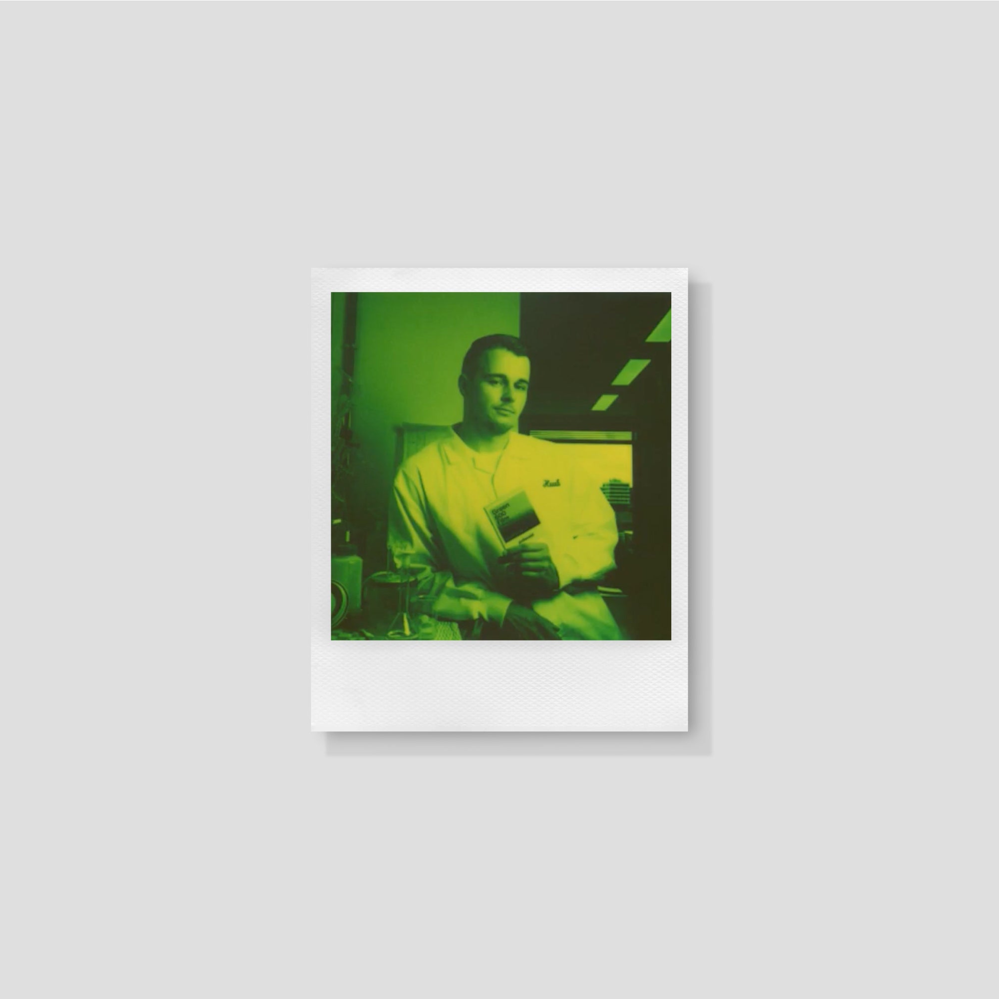 Polaroid Green 600 film pack showcased against a vibrant backdrop, highlighting its unique design and branding.