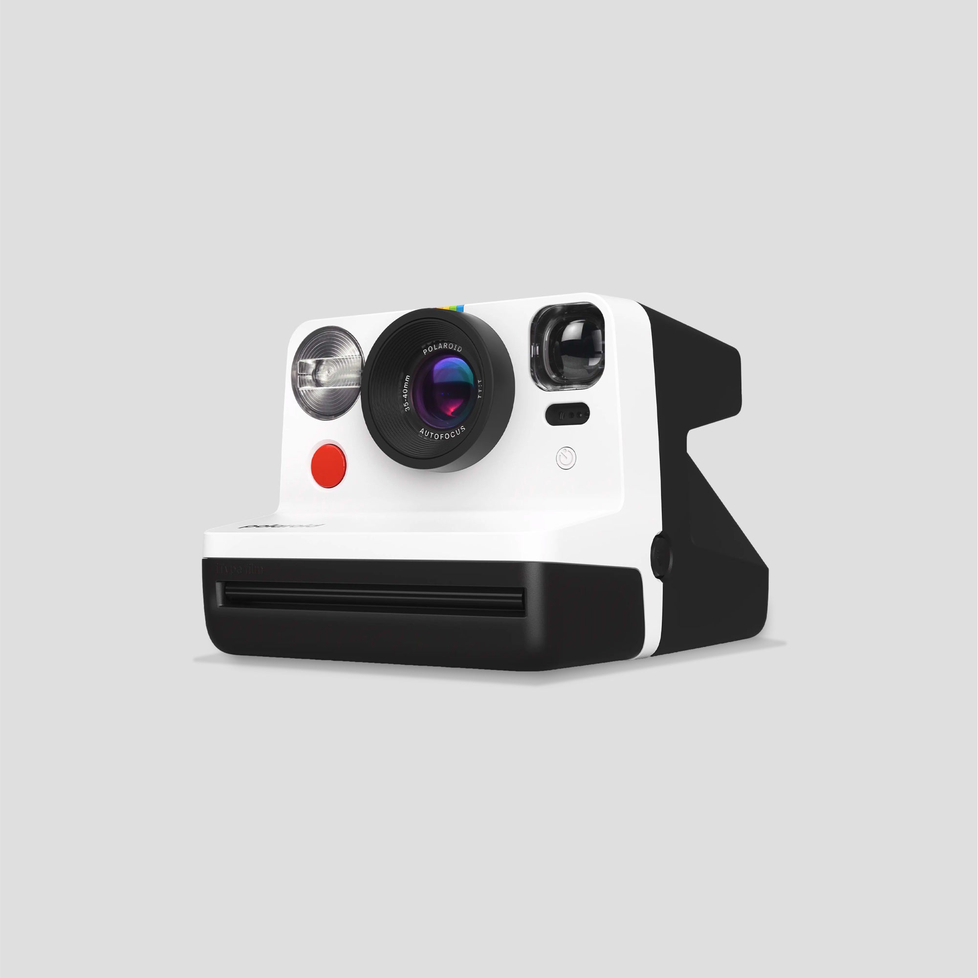 Polaroid Now Gen 2 instant camera on a wooden surface, showcasing its classic look and autofocus lens