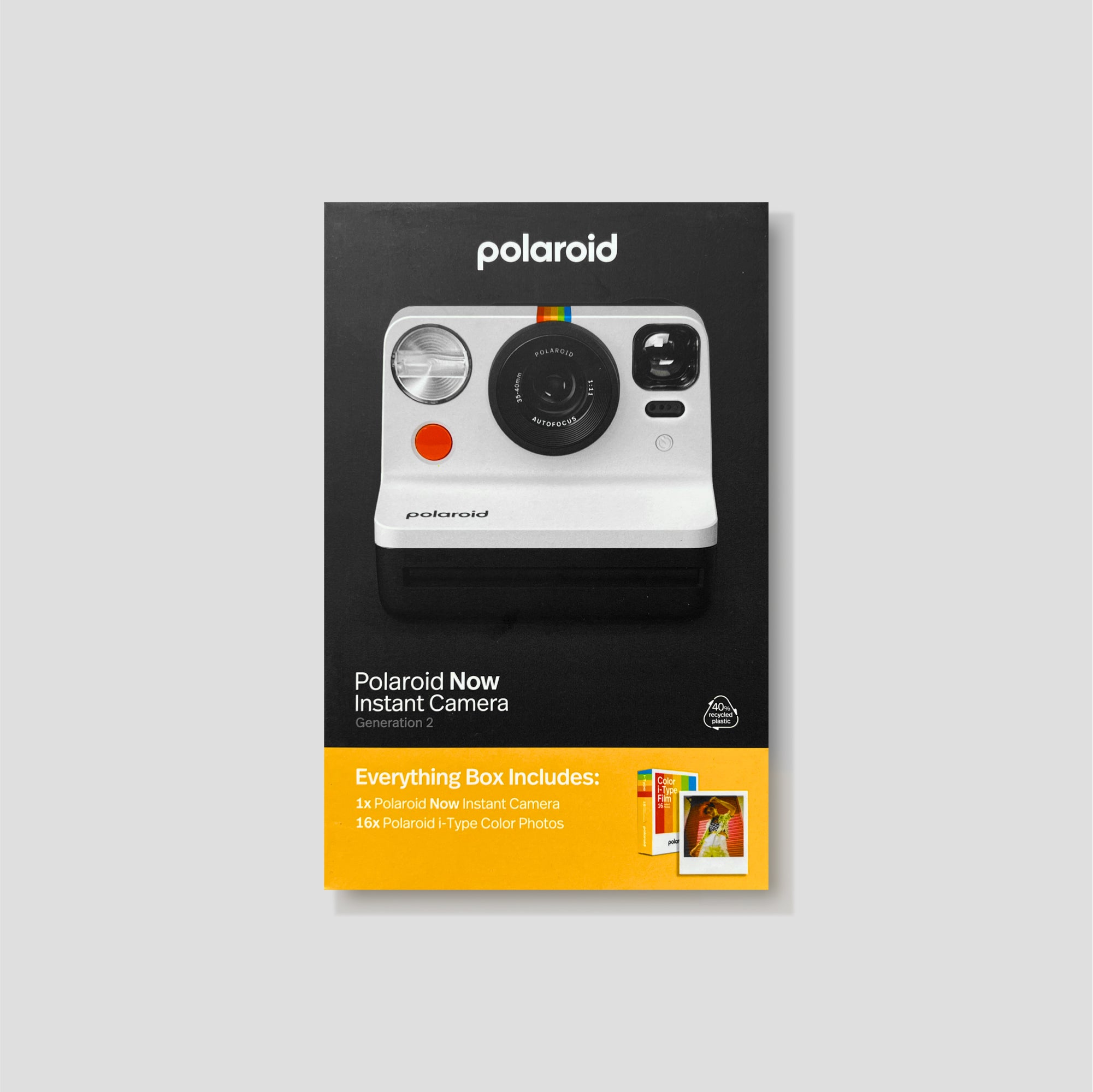 Polaroid Now Gen 2 instant camera on a wooden surface, showcasing its classic look and autofocus lens
