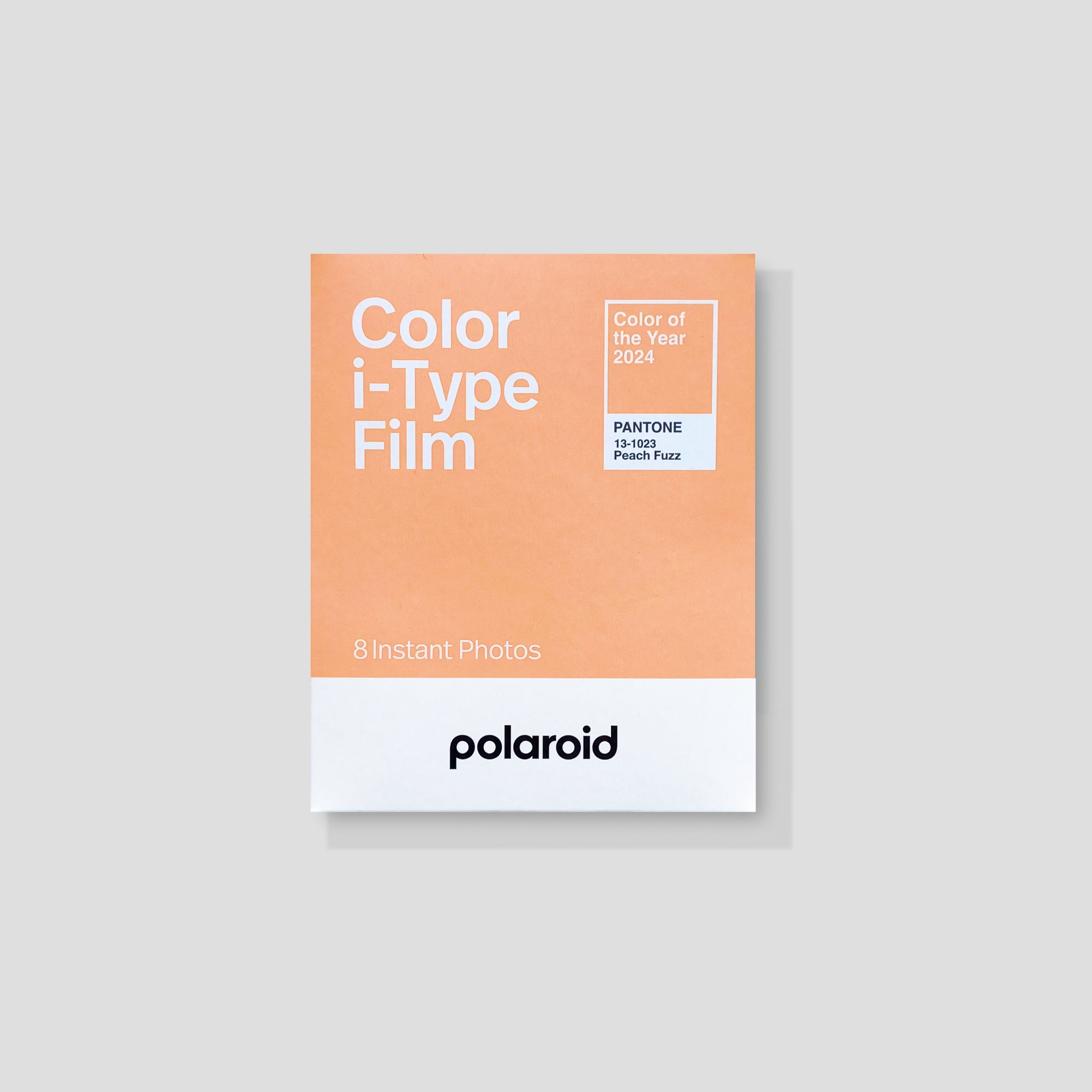 Close-up of Polaroid Peach Fuzz Instant Film showing vibrant colors and packaging.