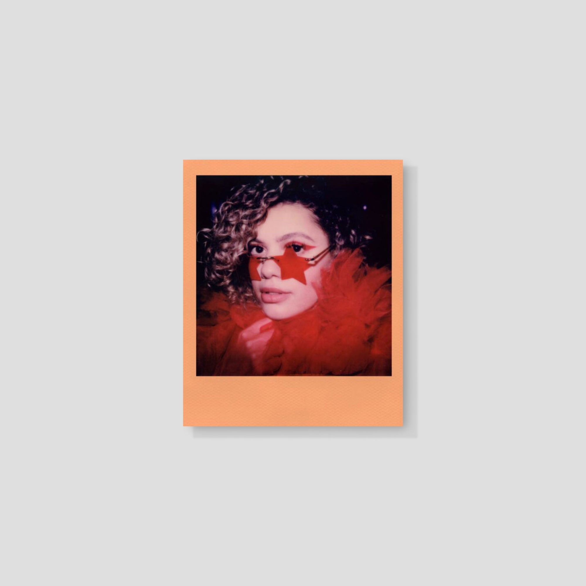 Close-up of Polaroid Peach Fuzz Instant Film showing vibrant colors and packaging.