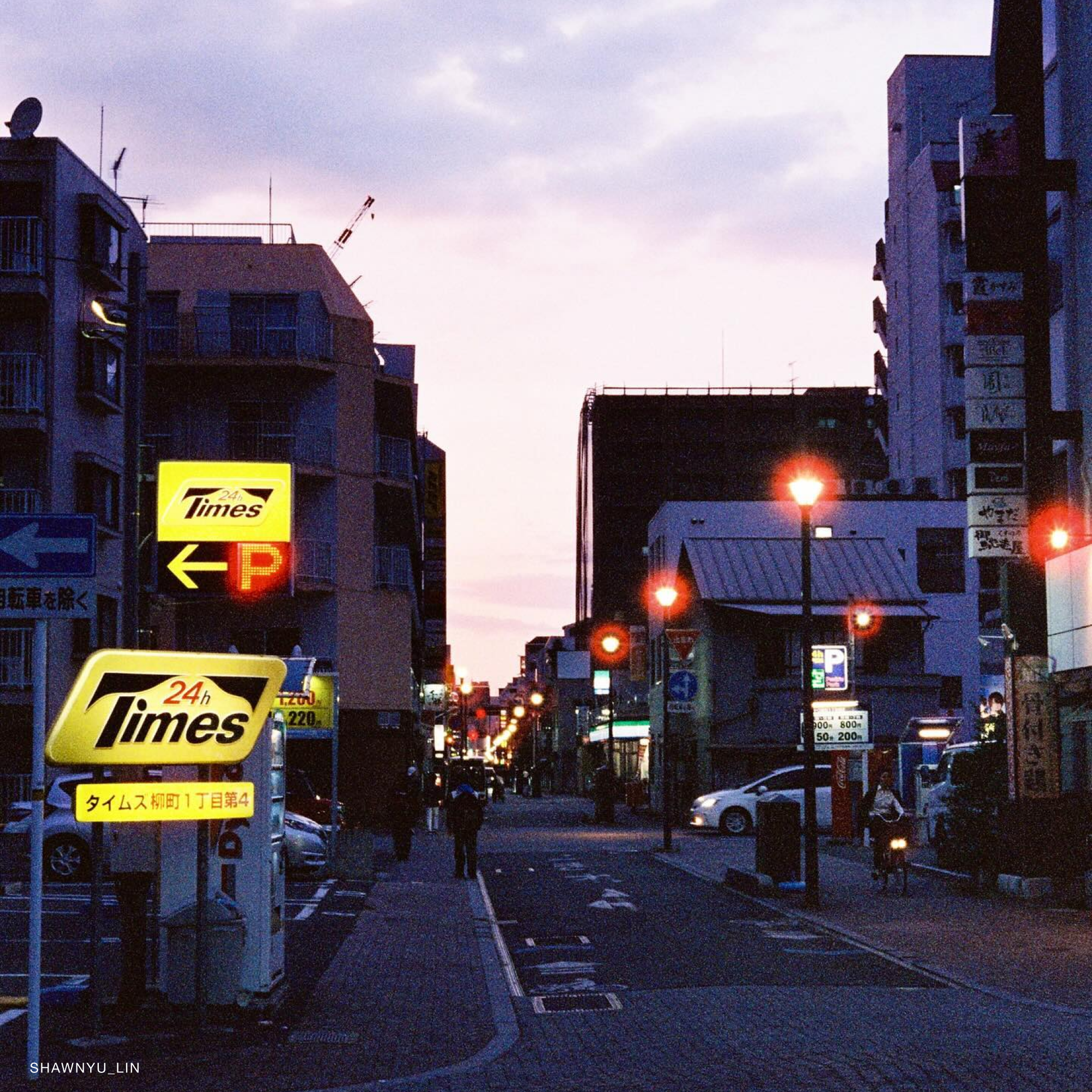 Photographer using Reflx Lab 800T in a dimly lit setting, capturing vibrant night scenes.