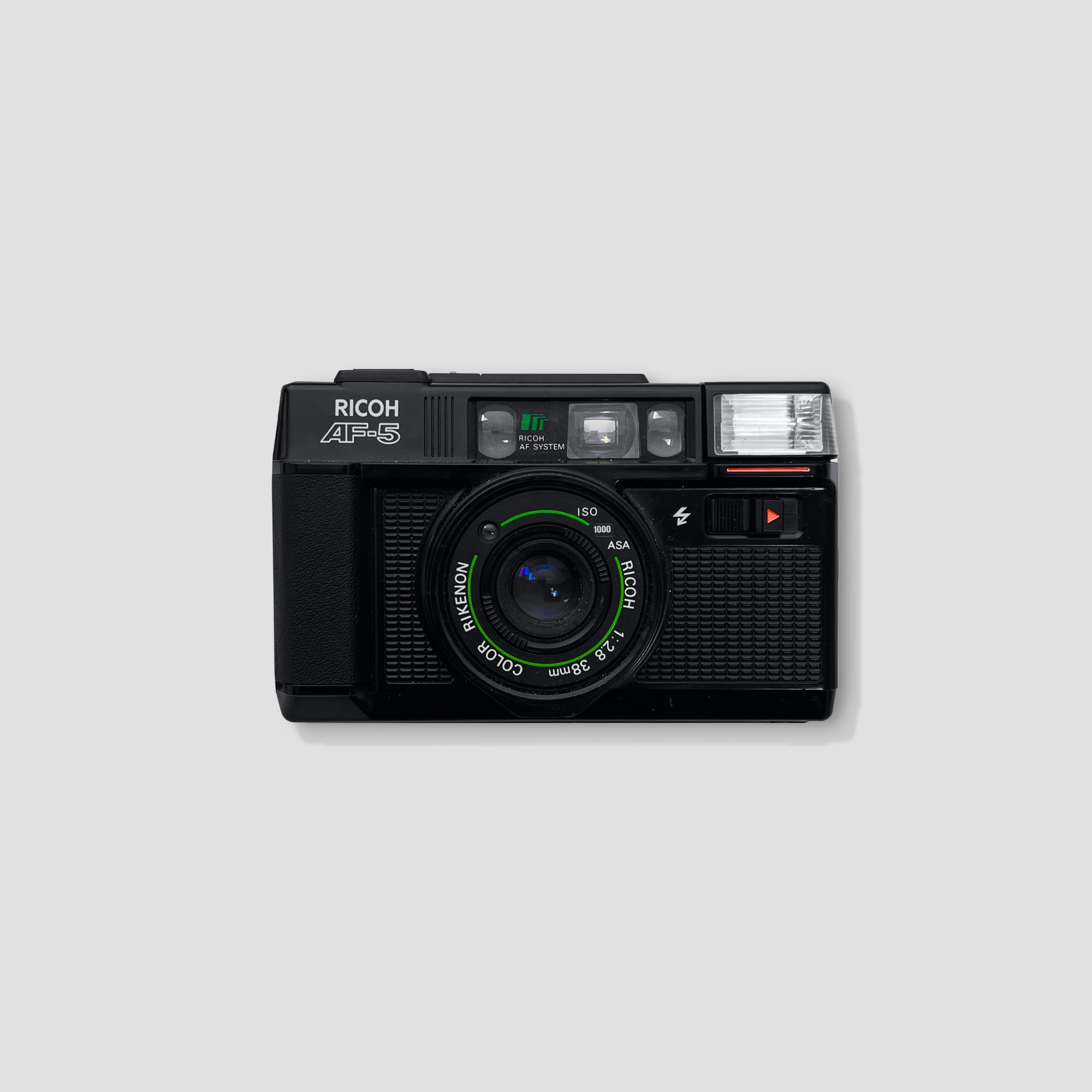 Ricoh AF-5 compact 35mm camera showcasing its stylish design from a side angle.